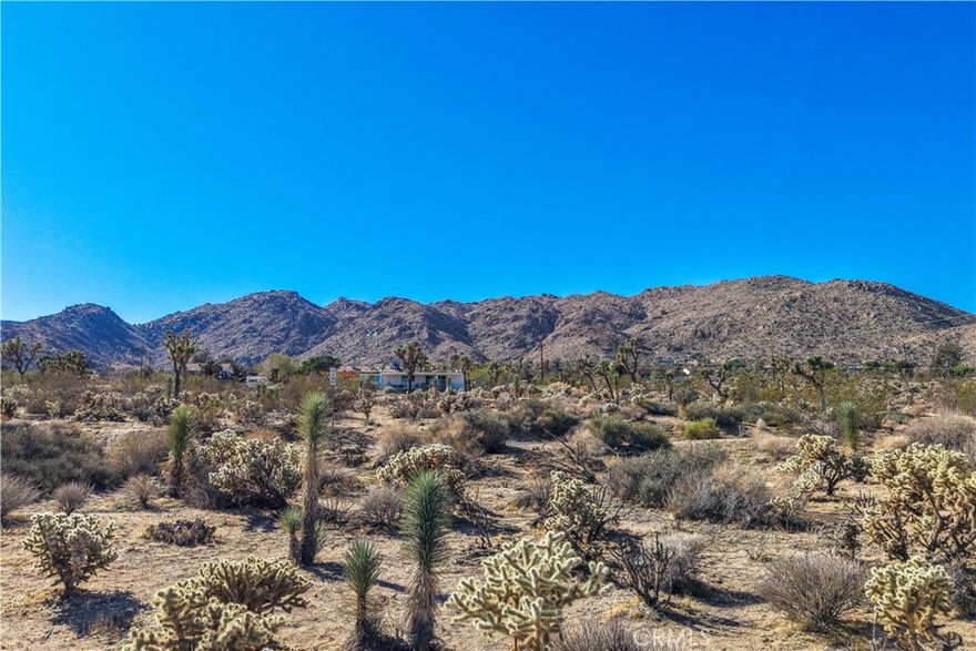 Enjoy breathtaking desert and mountain views from this 19,014 square foot parcel located in the highly desirable Upper Friendly Hills neighborhood of Joshua Tree. This buildable lot offers the perfect opportunity to create your dream home, vacation getaway, or investment property in one of the area’s most sought-after locations. Utilities are believed to be available at the street—buyer to verify.
Just minutes from Joshua Tree National Park, downtown Joshua Tree, and the famous Joshua Tree Music Festival, this location combines peace and privacy with easy access to local cafés, shops, and art galleries. Explore hiking trails by day and stargaze under the clear desert sky by night—this is the best of the Hi-Desert lifestyle.