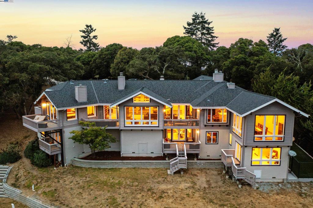 Expansive Coastal Retreat located in the Aptos-Larkin Valley area - Welcome to your dream sanctuary—where space, serenity, and panoramic views meet refined design and modern functionality. Set on the hill just 8 minutes from charming Aptos Village, this property offers a rare combination of privacy, natural beauty, and multigenerational flexibility. Wake up to sweeping views of the ocean and green rolling hills, framed by a home designed to celebrate light, comfort, and connection. Thoughtfully designed with rich natural textures—stone, glass, wood, and soaring ceilings. This residence invites the outdoors in, with skylights and sun-filled rooms enhancing every moment. Ideal for multigenerational living or guest accommodations, the property features a separate lower-level studio and additional bedroom spaces with potential for expansion. Each bedroom opens to a private porch, creating personal outdoor havens throughout. Equestrian enthusiasts will appreciate the proximity to boarding stables and riding trails—all within a two-mile radius. There’s ample room to create your own outdoor oasis: think pool, gardens, entertaining terraces, or even a hobby farm.The spacious kitchen and family room are made for gathering, while the private primary suite offers a tranquil retreat
