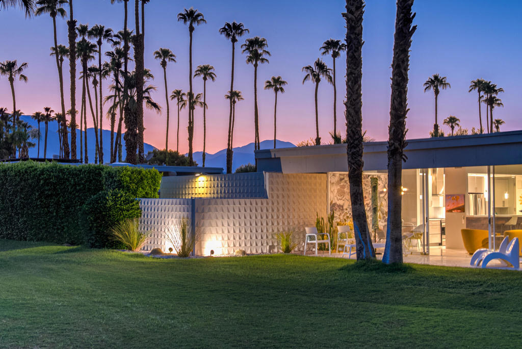 This beautifully remodeled 2bed/2bath home is just waiting for you to call home at the coveted Seven Lakes Country Club. Originally designed by Richard A. Harrison, inside its mod shadow-blocked walls, you'll find a spacious unit updated for today's living. Spread out over the 1,545 sq ft open floor plan, highlighted by light terrazzo tile floors, and get ready to entertain in style! The remodeled kitchen is finished with KraftMaid grey cabinetry, sparkling stainless steel appliances, and ample quartz countertops, including a large breakfast bar. Walls of glass sliders open out onto a green leisure terrace with views of the mountains and the iconic Southridge estates. Enclosed for maximum privacy, the northern window wall opens onto a large private courtyard lined with a desertscaped perimeter garden. Both bedrooms offer great closets as well. An assigned two-car garage is available, assigned space is on the left, while the tranquil pool is just steps away. The roof has been recently recoated as of July 2025. Past the 24-hour guarded front gate, 'The Gem of the Desert' offers a unique elevated lifestyle with its Ted Robinson-designed 18-hole executive golf course, 15 pools and spas with poolhouses, and the lively William Cody-designed clubhouse with a formal dining room, casual cocktail lounge, and a terrace overlooking the waterfall-fountain. Welcome home!