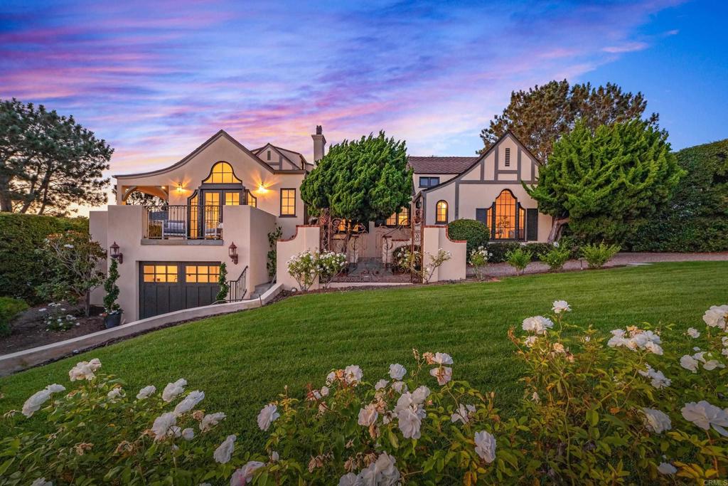 A rare offering on one of Olde Del Mar’s most desirable streets, this iconic English Tudor-style residence captures the historic charm and architectural elegance of a bygone era. The home sits on an oversized, fully usable lot with breathtaking ocean views from nearly every room in the house. This quiet, private property is just a short walk to Del Mar Village and the beach. Originally built in 1926 and tastefully expanded and updated in 2014, architect Rich Bokal honored the Tudor style and added refined modern touches, preserving key architectural elements, including the original detached carriage house and charming gravel drives, blending old-world character with contemporary comfort. Luxury details like marble countertops, double ovens, designer tile, and a built-in wine fridge complete the space. The formal dining room features soaring vaulted ceilings and arched French doors, an inviting setting for coastal entertaining. The main-level primary suite is a serene sanctuary where timeless elegance meets modern comfort. Featuring rich hardwood floors and French doors that open to a lush backyard oasis, this peaceful retreat is filled with natural light and charm. The en suite bath is beautifully updated with an oversized marble shower, combining classic sophistication with contemporary style. The original detached carriage house offers a rare opportunity for transformation. With two levels and generous square footage, it has the potential to be beautifully reimagined as a 1-bedroom, 1-bath guest house or ADU. There's ample space to incorporate a kitchenette and comfortable living area, all while preserving its historic charm. Don’t miss this extraordinary opportunity to own a piece of Del Mar history where timeless architecture, modern luxury, and an unbeatable coastal view location come together to create a truly one-of-a-kind legacy property.