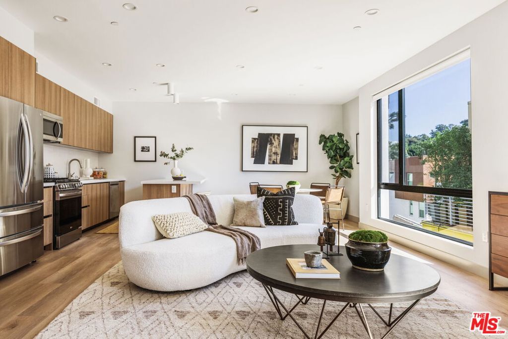Graciously sited in the hills, this community of 3 townhome style units is accessed by a private and gated driveway with guest callbox and entry. Clean, modern design with spacious, light-filled interiors are enhanced by elevated finishes throughout this 3 bedroom floor plan of nearly 1,800 sf. The open concept main level offers living area with balcony, plus fully equipped kitchen with brand new appliances, lots of storage, eat-in kitchen and dining area. A bedroom and full bathroom complete this level. Upstairs, expansive primary suite with walk-in closet with built-ins, private pocket balcony, and bathroom with dual sink vanities and shower. This level also offers guest suite with bathroom plus dedicated home office space. Take in sweeping views from the huge private roof top deck of Silver Lake's green hillsides, San Gabriel Mountains, and the DTLA skyline. An oversized 2-car garage also features side-by-side laundry area and EV charging ready for your Tesla, Jeep, or Audi! Rarely found privacy, level of finish, and spectacular views, along with close proximity to the best amenities in Silver Lake, and walking distance to the Reservoir. A chic, special place to call home. Property is being leased unfurnished.
