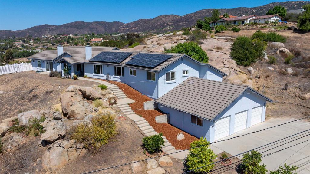 Welcome to this peaceful single-level retreat offering an open floorplan and soaring high ceilings. The large living room features a cozy fireplace and expansive windows showcasing beautiful westerly views with peek-a-boo views of the ocean. The spacious kitchen is equipped with stainless steel appliances, a walk-in pantry, and recessed lighting. A second living area/library provides flexibility for work or relaxation. The primary suite boasts its own fireplace, walk-in closet, and a luxurious ensuite with walk-in shower and separate tub. Additional highlights include spacious bedrooms, a 3-car garage, paid solar, RV parking, and a fully fenced back yard. Step outside to enjoy a sparkling pool and spa, creating the perfect setting for gatherings or quiet evenings at home. Conveniently located close to town, within walking distance to school, and with fire hydrants located nearby, this exceptional property blends comfort, function, and style—ready to welcome you home.
