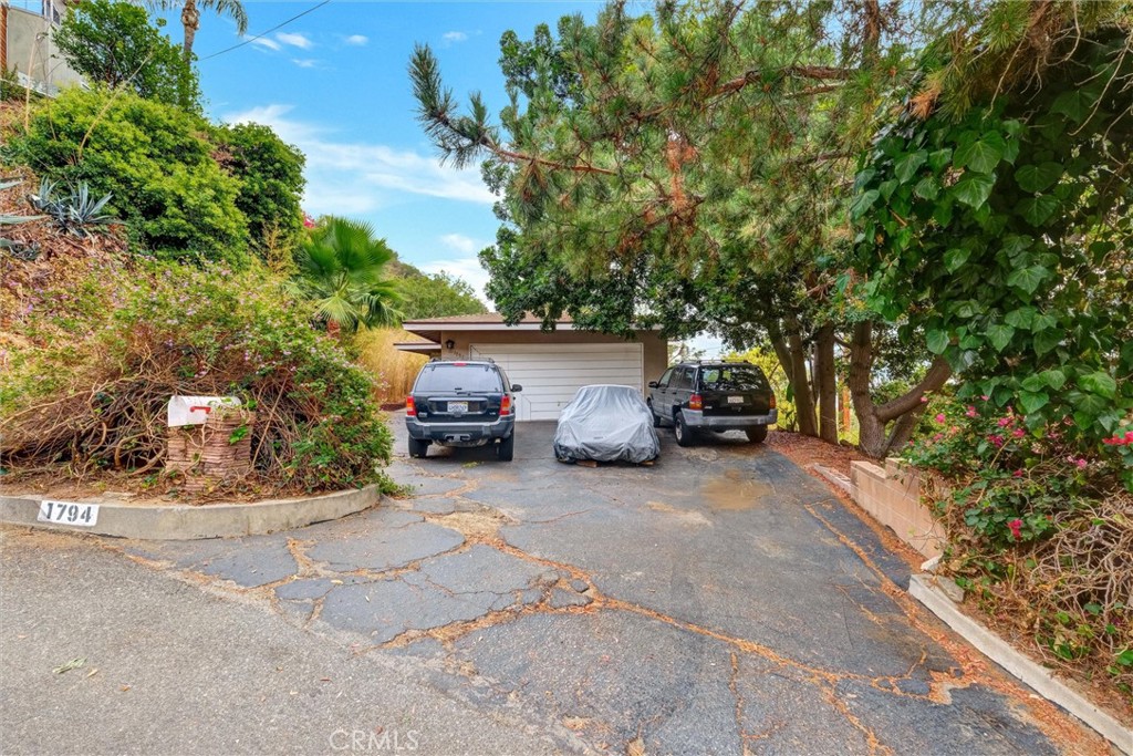 Perched near the top of the Burbank Hills, this private Mid-Century Modern offers city-lights views and timeless architectural character. Large windows in the spacious living room capture the scenery and view while the fireplace creates a warm gathering space. A second fireplace anchors the den, which can easily be converted into a fourth bedroom if desired. The primary bedroom suite features an attached dressing room and a three-quarter bath. Two more additional good sized bedrooms and a second full bath. Last sold in 1999, this incredible home is ready for its next chapter. With thoughtful updates, it has the potential to become a modern showpiece while retaking its' mid-century charm.