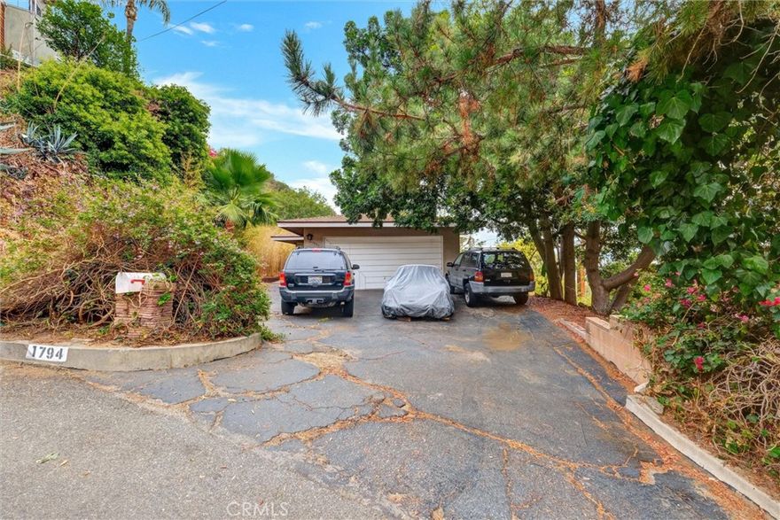 Perched near the top of the Burbank Hills, this private Mid-Century Modern offers city-lights views and timeless architectural character. Large windows in the spacious living room capture the scenery and view while the fireplace creates a warm gathering space. A second fireplace anchors the den, which can easily be converted into a fourth bedroom if desired. The primary bedroom suite features an attached dressing room and a three-quarter bath. Two more additional good sized bedrooms and a second full bath. Last sold in 1999, this incredible home is ready for its next chapter. With thoughtful updates, it has the potential to become a modern showpiece while retaking its' mid-century charm.