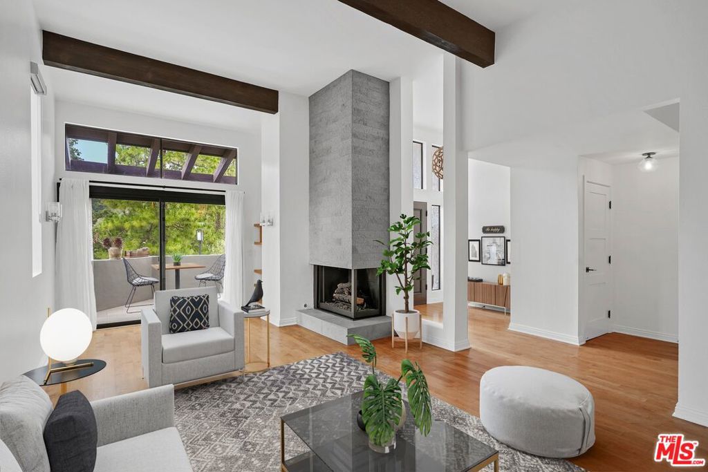 Discover the perfect blend of privacy, serenity, and stylish living in this beautifully updated Michael Lane townhome, nestled in the coveted Palisades Highlands. With sweeping canyon views and an abundance of natural light, this split level two-story residence offers a peaceful retreat from city life. Inside you'll find a light-filled interior featuring high vaulted ceilings, two spacious bedrooms, a formal dining area, and a charming breakfast nook just off the gourmet chef's kitchen thoughtfully designed with premium finishes. Recent upgrades include an elegantly remodeled primary bathroom, a stylish powder room, and a direct-entry two car garage complete with washer/dryer and an additional refrigerator for added convenience. The two bedrooms have ensuite bathrooms and the primary bedroom has a large walk-in closet. Decorative carpet stair runners add warmth and charm at every level, while downstairs, the open layout flows effortlessly into inviting living spaces perfect for both everyday comfort and entertaining. Enjoy resort-style amenities including a sparkling community pool, rejuvenating sauna, and fully-equipped gym, a short distance from the front door. For nature lovers, scenic hiking trails and outdoor adventures await just moments away, offering the ideal setting for a healthy, active lifestyle. Unfurnished unit, no pets. Although the Palisades fires in early 2025 did not impact this home directly, all "walls-in" components and ductwork and attic spaces have been professionally remediated by ServePro for added peace of mind. In addition, for three months top-of-the-line BluAir HEPA filters have been operating throughout the townhouse to ensure cleaner fresher air in the residence.