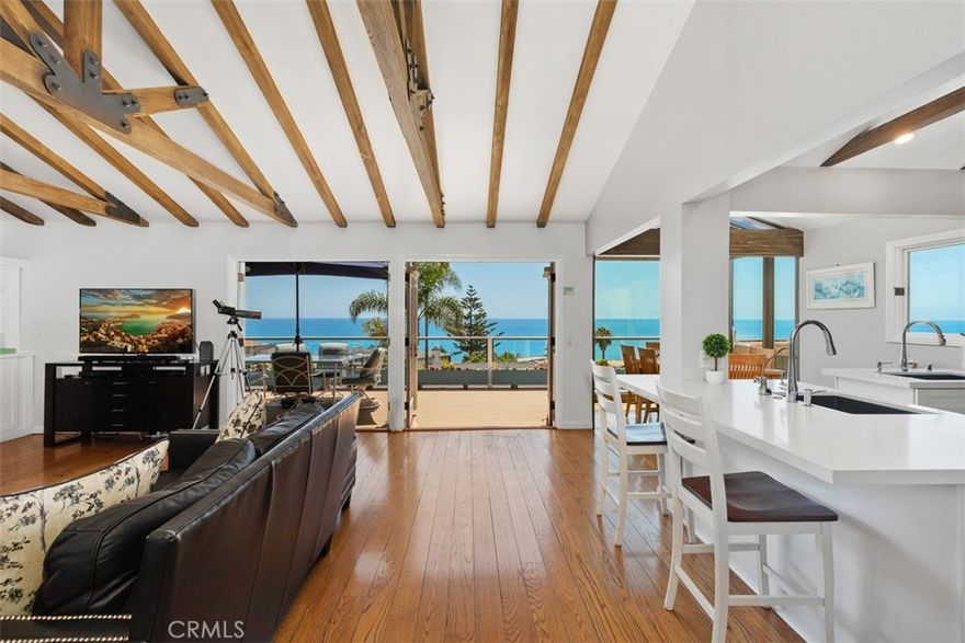Nestled on a quiet street two blocks above Victoria Beach with sweeping 180-degree views of the glistening Pacific Ocean and up the coast to Long Beach Harbor, marvel at the spectacular sunsets over Catalina Island from the comfort of your living room with a fireplace, the dining area, and the deck. With 2 stories and nearly 2,400 square feet, this 3-bedroom, 3-bathroom coastal property can be leased furnished or unfurnished.  Boasting a primary bedroom suite with soaking tub and walk-in shower, 2 additional bedrooms, plus two additional well-appointed bathrooms, a large bonus room/office area with built-in cabinets and file drawers, and a wet bar and fireplace. The house also has a dual-zone central air conditioning system.  As night falls, cozy up by one of the two fireplaces or gaze at the twinkling city lights below. Experience the Mediterranean climate and expansive ocean views right at your doorstep. Laguna Beach offers a unique topography with nearly 8 miles of coves and beaches, perfect for exploring sea caves, tide pools, and sandy shores. Whether you're looking to hike the picturesque canyons, surf the pristine waves, or soak up the sun, there's something for everyone here. Don't miss this opportunity to make your coastal living dreams come true.