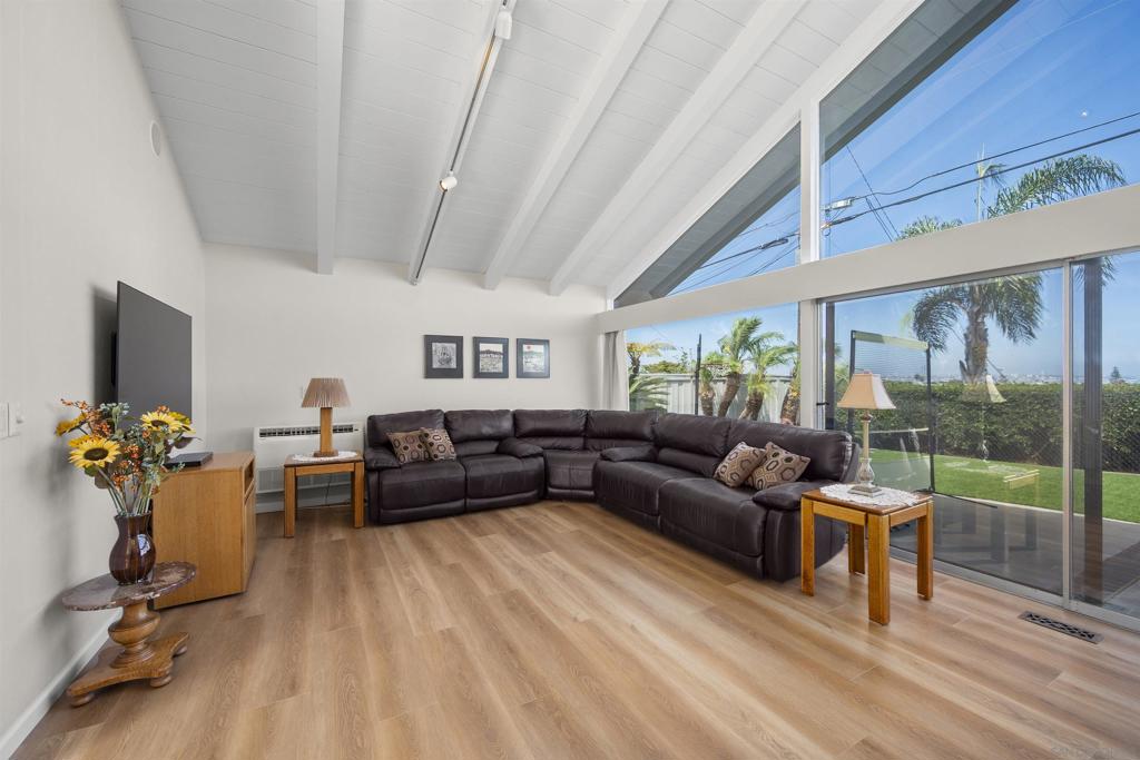 Welcome to 1151 Catalina Blvd, a stunning home in Point Loma with breathtaking views of San Diego Bay, the downtown skyline, and mountains beyond. Perfectly located minutes from top attractions, this 5-bed, 3.5-bath residence offers elegance, comfort, and energy efficiency with a fully owned solar system.  A beautifully paved circular driveway leads to a serene atrium with floor-to-ceiling windows. Inside, dual primary suites provide luxury, with the upper-level retreat featuring vaulted ceilings, a private balcony, and a spa-like ensuite with dual vanities, a walk-in closet, and three extra closets.  Designed for function and style, the kitchen boasts granite countertops, dual ovens, European-style cabinetry, and high-end appliances. The family and formal living rooms each showcase custom marble fireplaces, enhancing warmth and sophistication.  Indoor-outdoor living shines, as two main areas open to a sprawling backyard with panoramic Bay, Harbor, and mountain views—perfect for entertaining or relaxing.   This extraordinary home won’t last long—schedule your tour today!