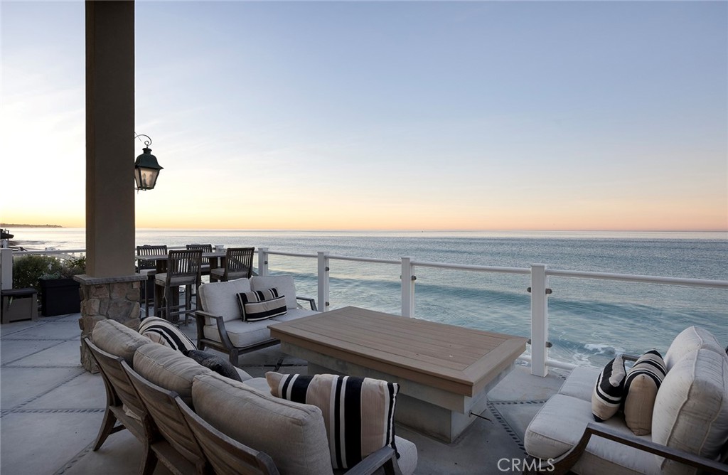 Immerse yourself in luxury at this exquisite fully furnished oceanfront home, a true jewel in Orange County's most coveted coastal neighborhood. Commanding a prestigious position on Beach Road, this home stretches across a 1.7-mile sandy expanse, nestled between the San Clemente Pier and Dana Point Harbor. Experience the epitome of Southern California's "California Riviera," a secure, private haven offering unparalleled views and serenity, 24-hour gated security included. A symphony of design, the home is a collaboration between renowned architects Bryant, Palmer, Soto, and interior designer Lane McCook. Its floor plan masterfully embraces the stunning ocean vistas, with the primary living areas overlooking the endless sea. The entrance ushers you into a lower level adorned with several sitting areas, soaring double-height ceilings, and a unique concrete-and-river-stone flooring blend. Crafted for the connoisseur, the home boasts three A/C zones and a private elevator accessing all levels. The oversized deck, complete with a fire pit and beach stairway, merges effortlessly with a casual living area through LaCantina sliding doors, creating an enviable indoor-outdoor space. The main living area above features a cozy fireplace and dining space, adjacent to a kitchen that epitomizes sophistication. White cabinetry, light marble countertops, and a backsplash complement the high-end Wolf range and SubZero refrigerator. Notable kitchen additions include a butcher-block island, built-in credenza, and walk-in pantry. This level also houses a spacious laundry area, powder room, and a home office currently serving as a podcast studio. Ascend to the upper level to discover four ensuite bedrooms, culminating in the grandeur of the Primary Suite. Here, panoramic windows, a vast deck, and wood-paneled walls frame the breathtaking seascape. The primary bathroom indulges with black herringbone flooring, floating dual vanities, a spacious shower, and a standalone bathtub positioned to soak in the ocean views, extending from Dana Point Harbor to San Clemente. Seasonal rates range from $30,000 to $45,000, varying with availability.