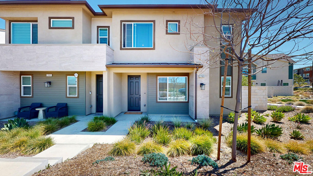 Welcome to 27651 Ensemble Place one of the largest homes available, in the highly desirable community of Valencia, featuring OWNED SOLAR! This beautifully upgraded 4-bedroom + 3-bath home offers over 2,200 sq ft of light-filled living space and is move-in ready with completed landscaping and premium finishes throughout. Step inside to find modern touches including wood-paneled accent walls, plantation shutters, quartz countertops, a spacious walk-in pantry, and a chef's kitchen with a large center island, stainless steel appliances (fridge included), and shaker cabinetry with matte black hardware. The open-concept layout flows effortlessly through oversized multi-slide doors to your private, low-maintenance yard with pavers and turf perfect for indoor/outdoor living. Upstairs features four spacious rooms , convenient laundry room. The primary suite impresses with TWO walk-in closets, a large walk-in shower, dual sinks, and a private water closet. Additional highlights include a 2-car attached garage, guest parking right outside, and stylish bathrooms with quartz finishes.Enjoy resort-style living with access to Five Point's exclusive amenities: sparkling pools/spas, BBQ areas, community garden, playgrounds, trails, a state-of-the-art rec center, and more. Ideally located minutes from the 5 freeway, Six Flags, shopping, dining, award-winning schools, and future commercial spaces and schools. This is luxury lifestyle, and Fantastic location don't miss this rare gem.