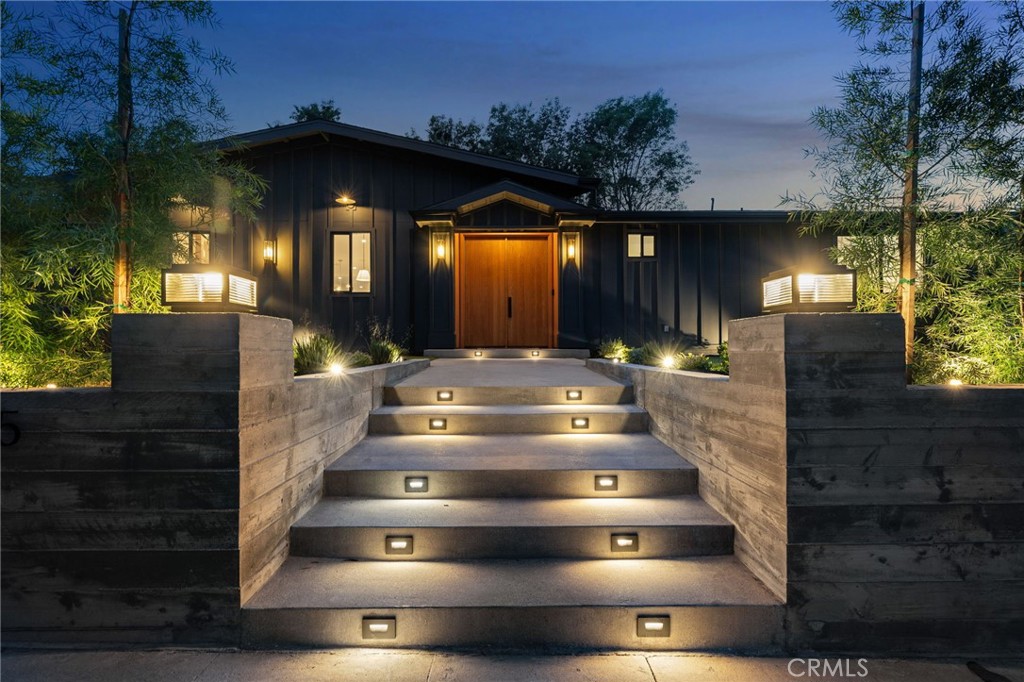 Welcome to a breathtaking, expanded and fully reimagined modern farmhouse, ideally located south of the boulevard in the prestigious Vista De Oro enclave of Woodland Hills. Situated on an expansive wide lot with approximately 120 feet of street frontage, this stunning single-story residence combines timeless design with luxurious modern living. Step inside to soaring 10-foot ceilings and an open-concept floorplan bathed in natural light, with oversized sliding doors that seamlessly blend indoor and outdoor living. Wide plank European oak floors, designer and recessed lighting, and custom white oak built-ins create a warm yet sophisticated atmosphere throughout.The heart of the home is an exquisite chef’s kitchen, thoughtfully designed
with custom white oak cabinetry, elegant quartz countertops, a massive center island perfect for gatherings, and top-of-the-line professional appliances — including a show-stopping 60-inch range with double ovens. Retreat to the spectacular primary suite featuring sliding doors that open to the lush backyard, a spa-like en-suite bathroom with a separate soaking tub and oversized walk-in shower, and an extraordinary walk-in closet, fully customized to rival a designer boutique showroom. Additionally, there are three generously sized guest bedrooms, each with its own en-suite bathroom featuring designer finishes, offering comfort, privacy, and style for family and guests alike. The park-like backyard is a private oasis, offering a newly remodeled pool, a versatile sport court, and sprawling grounds perfect for entertaining, relaxing, and play. A rare offering blending style, comfort, and function in one of Woodland Hills’ most coveted neighborhoods — this is modern California living at its finest.
