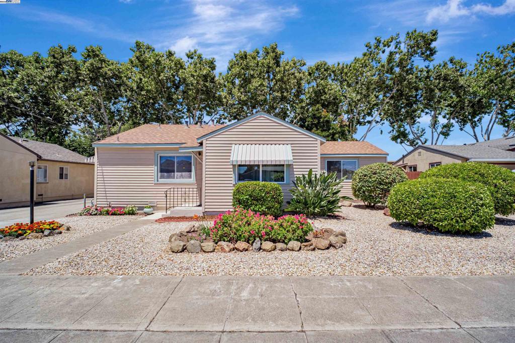 Discover the Charm and Practicality of this Well-Maintained One-Story Home. Single-level living boast several key advantages that contribute to a comfortable and convenient living. Much of the home retains its original hardwood flooring. The approximately 1,183 square feet of livable space is ideally designed for maximum space utilization. An open floor plan creates a warm atmosphere for loved ones. Enjoy a large eat-in kitchen that is immaculate and a living room offering lots of natural light. There is cam lighting in the living room and a blade modern ceiling fan. The home features three spacious bedrooms and two full bathrooms, includes a primary bedroom with a primary bathroom. Dual sinks, shower over tub, and two large closets and blade modern ceiling fan complete the primary bedroom. The middle bedroom has a glass sliding door leading to the backyard. Included in the backyard are a large natural grass area, a private hot tub and a separate building that includes electricity, multiple rooms for storage and a workshop. The beautiful front yard adds to the home's inviting curb appeal. The property offers three off-street tandem parking spaces. Enjoy being located near parks, shops, commuter routes, freeways and BART. Allow yourself to view this home. Welcome Home!