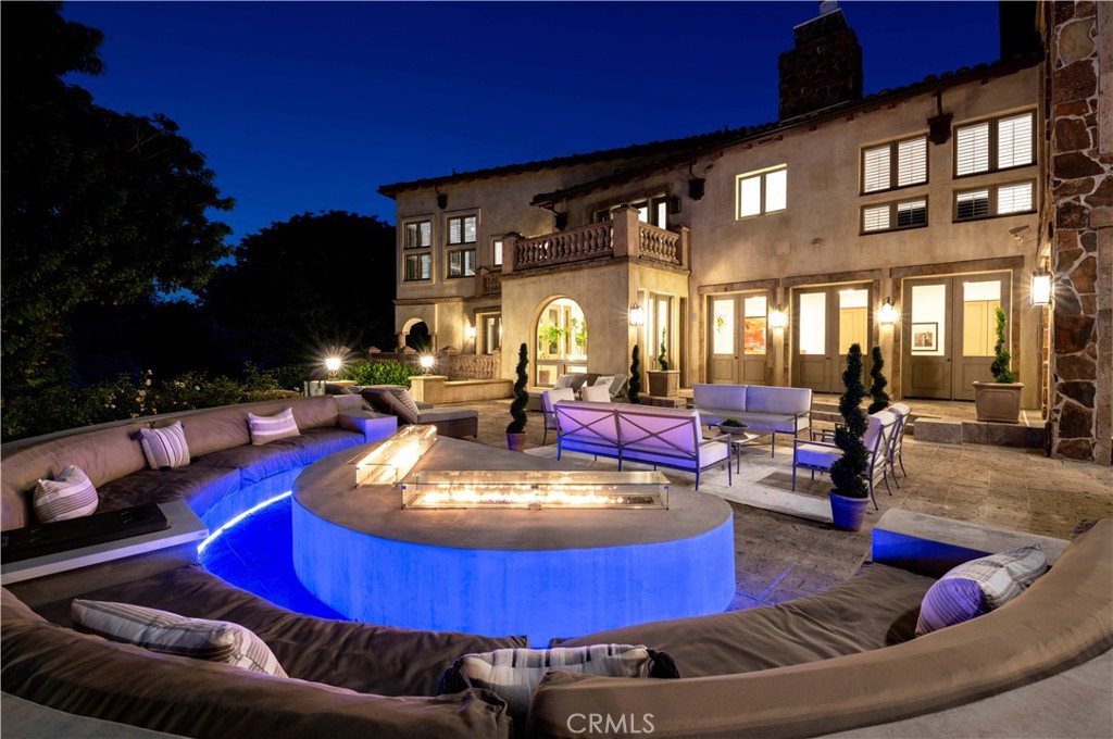 In the heart of illustrious Holmby Hills, 206 North Carolwood stands among a highly stewarded collection of world-class estates, where Hollywood royalty and global billionaires reside behind gates and manicured drives. Moments from UCLA, Rodeo Drive, the Bel-Air Country Club, and the famed Playboy Mansion, this address pairs architectural distinction with a lifestyle of enduring prestige.
Romanesque-inspired archways, soaring ceilings, and rich hardwood floors set a tone of quiet opulence. Designer finishes and refined lighting elevate every space. The formal dining room evokes classic Los Angeles elegance, while the chef’s kitchen and adjacent breakfast nook invite daily ease and entertaining. One living room opens onto a stunning arched loggia, seamlessly connecting indoor living to lush gardens—an architectural gesture as cinematic as it is elegant.
Outdoors, a descending staircase reveals a secluded lower pool and spa pavilion, enriched by mature gardens tailored for grand-scale entertaining. A custom-designed firepit with built-in seating offers an enchanting setting for twilight gatherings. Expansive terraces that further distinguish the estate’s livability.
Unparalleled access to the best of Los Angeles. A generational opportunity shown to prequalified buyers only.