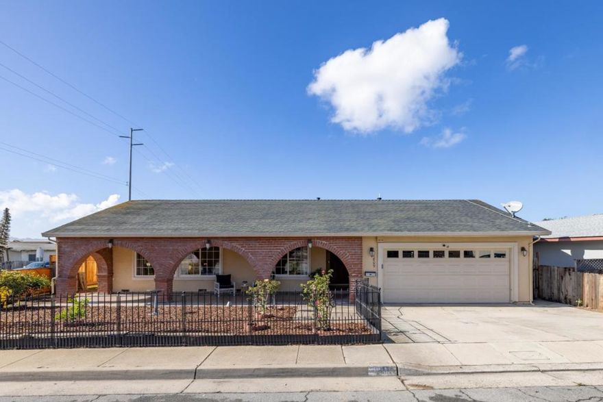Curved brick archways lend texture and distinction to this single-level home in Seaside. With a manicured rose garden in front and ocean views in the back, the property fully immerses residents in the sublime beauty of California's Central Coast. Whether preparing lunch in the kitchen, reclining in the living room, or indulging in an afternoon nap as a light breeze flows through an open window in one of four bedrooms, you'll always know exactly where you are. Just moments from some of the area's most beloved restaurants and minutes from Del Monte Beach, here is an opportunity to claim for yourself unmatched proximity to the Monterey Peninsula (and all the luxuries that come with it). That signature curve of the coastline as it runs along Cannery Row is unmistakable. Here, you can see it as you cook over your five-burner gas range, or relish a hot cup of espresso at the breakfast bar before starting your day in bliss. Attractive square-paned glass doors slide open in the kitchen to reveal an enormous back deck where the seascape continues. Gather here with friends around the fire pit on cool fall evenings to watch crimson sunsets. Bite into a ripe apple straight off the tree, or pick a juicy lemon to squeeze over your salad or into a fizzy cocktail. Let yourself live gorgeously.