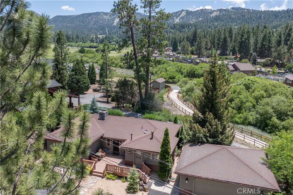 Dreaming of a mountain escape with incredible views and endless charm? This 3-bedroom, 2-bathroom retreat has it all! Enjoy panoramic ski slope views right from your backyard, complete with a private spa—ideal for soaking after a day on the slopes. The home welcomes you with an open-concept living area featuring wood floors and a cozy brick fireplace, seamlessly connecting to the kitchen and dining space for easy entertaining. All bedrooms and bathrooms are conveniently located on the main level. Downstairs, you'll find a spacious basement perfect for storage or transforming into your own wine cellar. The attached two-car garage has been converted into a fun-filled game room/man cave for year-round enjoyment. Set on a level lot with ample parking—including room for your RV or boat—this property also features exterior storage and mature fruit trees. Best of all, the Rathbun Creek Trailhead is right behind the property, offering immediate access to nature. Don’t miss your chance to own this beautifully maintained mountain getaway!