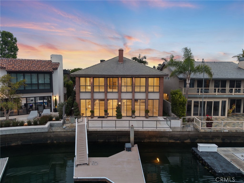 FAMILY TRUST AUCTION!!! SET BEHIND SECURITY GATES IN NEWPORT BEACH IN THE INTERIOR PRIVATE COVE ON COVETED LINDA ISLAND, IS A CHANCE TO PURCHASE ONE OF THE ISLAND’S MOST DESIRABLE PARCELS. POSITIONED ON A GENEROUS 7,500± SQ. FT. LOT, THIS EXCEPTIONAL PROPERTY OFFERS THE SCALE, PRIVACY AND ORIENTATION TO RESIDE IN ONE OF NEWPORT BEACH’S MOST ICONIC COMMUNITIES. THIS PROPERTY CAPTURES AWE-INSPIRING BAY VIEWS THAT STRETCH WESTWARD, DELIVERING A CINEMATIC BACKDROP FOR SOUTHERN CALIFORNIA’S FAMED BEACH COMMUNITY LIVING. AS YOU ENTER THE TWO STORY COMPOUND AND PASS THROUGH A GATED, PRIVATE COURTYARD, YOU ARE GREETED WITH A GRAND STRIKING AND SWEEPING CIRCULAR STAIRCASE, SOARING CEILINGS AND AN EASY FLOW INTO A SPACIOUS LIVING ROOM WITH INNER LAGOON VIEWS. THIS IMPRESSIVE 5 BEDROOM, 5 BATHROOM HOME COMBINES REFINED ELEGANCE WITH COMFORTABLE LUXURY. A 3 CAR ATTACHED GARAGE, FIREPLACES, WET BAR, GENEROUSLY SIZED UPSTAIRS EN SUITE BEDROOM, FORMAL DINING ROOM AND REMARKABLE CHEF’S KITCHEN WITH CENTER ISLAND, SUB ZERO REFRIGERATOR, BERTAZONI RANGE ARE A FEW OF THE NUMEROUS HIGHLIGHTED ELEMENTS THAT ACCENTUATE THE HOME. DINE AL FRESCO ON YOUR PRIVATE PATIO AS YOU LOOK OUT AT THE TRANQUIL WATER AND 50± FOOT BOAT DOCK. COME EXPERIENCE COASTAL LUXURY LIVING AT ITS FINEST. WELCOME HOME!