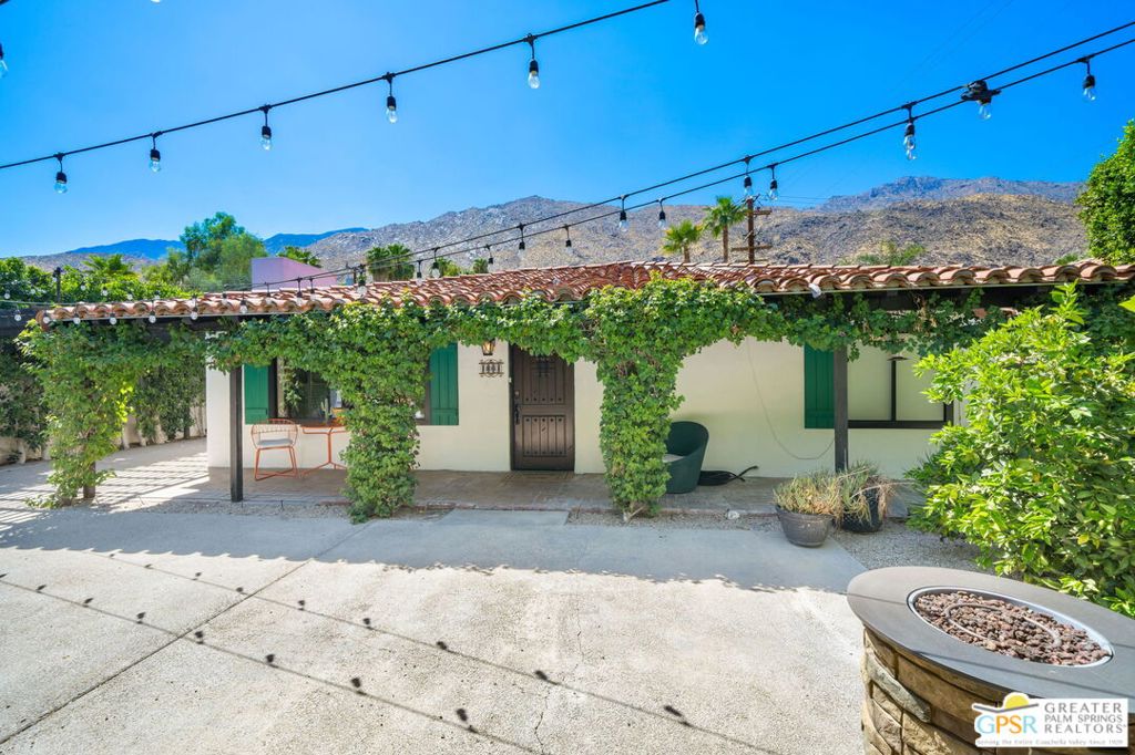 Welcome to The Mesa, a storied residential enclave nestled at the base of the majestic San Jacinto Mountains in South Palm Springs. This historic neighborhood boasts an eclectic mix of architectural styles that reflect the rich evolution of our city, and this home stands as a quintessential example of 1940s Spanish Colonial charm, thoughtfully updated for today's modern living. Step inside to discover a light-filled open-concept living, dining, and kitchen area, perfect for entertaining or relaxing in style. Upgrades include a newer central AC/HVAC system plus individual mini-split units in each of the three bedrooms, offering customizable climate control throughout the home. The kitchen features a spacious walk-in pantry with a second refrigerator and a stacked washer/dryer for added convenience. Behind a gated driveway, this 8,276 sq ft lot offers rare privacy with tall, lush greenery enclosing the serene outdoor space. Enjoy off-street parking, gas fire pit, and a sparkling pool with a covered lounge area, ideal for year-round desert living. With upgraded electrical, plumbing, and gas lines already in place, this move-in ready home is the perfect blend of classic style and modern comfort. Whether you're searching for a full-time residence or a weekend retreat, this tranquil oasis in The Mesa is ready to welcome you home.