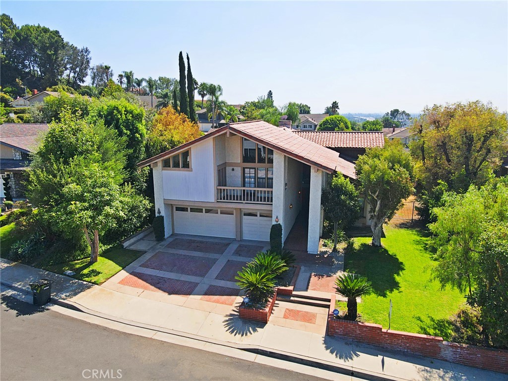 Beautiful estate in the hills of Orange! This home has been well maintained over the years and is an amazing condition. Located in a highly desired neighborhood and quaint street, this Home has four bedrooms (ONE MAIN FLOOR BEDROOM WITH ACCESS TO FULL BATHROOM), three bathrooms, as well as a huge bonus room/bar room/game room with a wraparound balcony and beautiful city light views.
This home has lots of real wood, cabinetry, doors, and staircase railings. With cathedral ceilings and very open living space this home can suit many families needs. Bedrooms are generously sized and have ample closet space. The master bedroom has soaring ceilings and plenty of natural light as well as an enormous walk-in closet with an additional his in her closet. The master bathroom has a separate tub and shower as well as plenty of storage space! The upstairs landing area is wide and spacious, and has a wonderful layout. The circular kitchen features stainless steel appliances and has a picturesque Window to the lush backyard. The backyard features a wraparound pool with a large side yard area as well as to covered lattice patios. The front yard has tons of curb, appeal with large grassy areas and low maintenance trees and shrubs.
Do not miss this opportunity to live in this highly desired area of Orange, with close access to freeways, award-winning schools, prestigious Orange, Lutheran high school, and nearby, restaurants and shops.