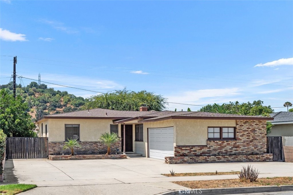 Located in the desirable Glendora Unified School District, this single-story 3-bedroom, 2-bathroom home offers a spacious layout with a bonus room ideal for a second living area, extended dining, or multi-use space. All bedrooms are generously sized, with a convenient Jack-and-Jill bathroom connecting two of them. The kitchen features ample cabinet space and a newer refrigerator. Additional highlights include an indoor laundry room with a newer washing machine and gas/electric dryer hookups, laminate flooring throughout, and newer window blinds. Recent upgrades include a brand-new roof, new water heater, and a newer patio cover for shaded outdoor enjoyment. A spacious two-car garage, circular driveway, and RV access provide ample parking. Conveniently located near Glendora Village, shopping, dining, parks, hiking trails, and with easy access to the 210 Freeway, this home offers comfort, functionality, and a prime location.