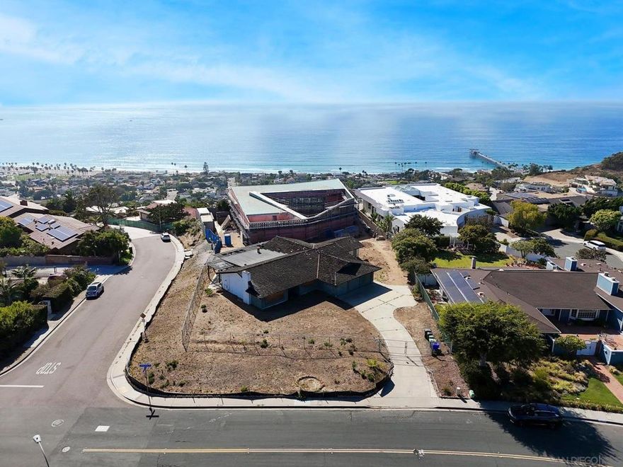 Prime Prestwick Estates expansive corner lot with unexpected and excellent views of the Cove and Pacific! The flat lot currently features a 4-BD single-story home and offers a wonderful opportunity to build a dream ocean-view estate. Plans have been submitted for a stunning 6,500-square foot 5 BD/5 BA contemporary with everything you need to live the fabulous La Jolla lifestyle. The property’s Upper Shores location delivers incredibly easy access to the beach, Village, UTC, freeways, and award-winning schools.