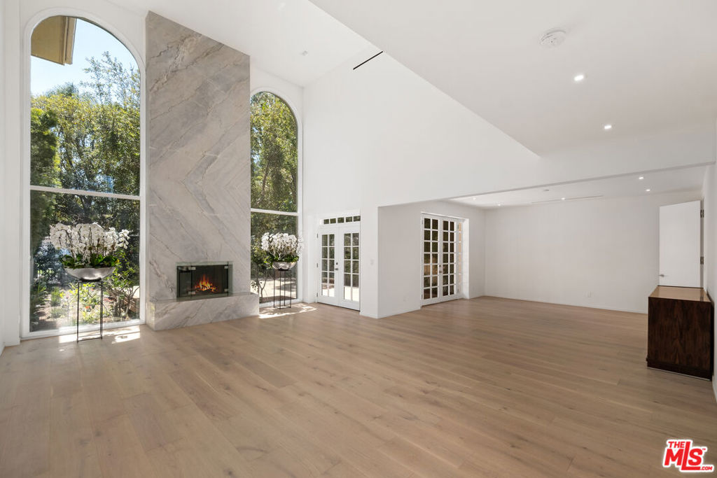 Located within the exclusive 24 hour guard-gated Mountaingate community in Brentwood. This breathtaking, newly remodeled, designer home offers great indoor/outdoor living and entertaining space. As you step inside, you are greeted by a double height entry with gorgeous French oak flooring. Lavish finishes and fine materials include marble imported from Italy as well as custom imported Italian doors, designer light fixtures and brand new HVAC system. This incredibly upscale home has an abundance of natural light, soaring ceilings and an exceptional layout consisting of three bedrooms, three full bathrooms and over 3,000 sq. feet of living space. The main level includes a living room with tall ceilings, dining room, and chefs kitchen with custom cabinetry and Miele appliances. Also, on the main level, you have one bedroom/office with an ensuite bathroom. On the second level, you have two additional ensuite bedrooms including a luxurious primary suite with custom designer closet, marble bathroom and a balcony overlooking the spacious backyard. Mountaingate is a prestigious gated community in the Los Angeles area, offering resort-like amenities including controlled gated access, community pool, jacuzzi, additional guest parking, 24 hour security patrol, and two tennis courts. Conveniently located near the 405 freeway, hiking trails, and both the west side and the valley.