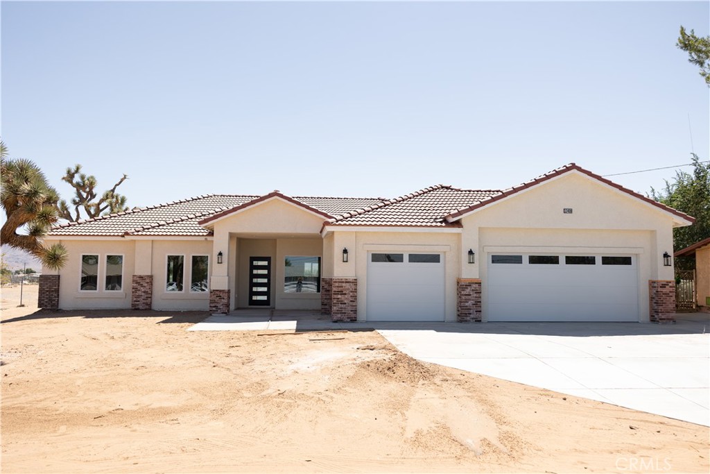 This stunning fully fenced 4-bedroom, 2.5 bath property is nestled in Apple Valley. Home offers 2,218 square feet of modern comfort, designed for both relaxation and entertaining. Flowing throughout this gorgeous home is wood-look tile floors which offers a warm appearance. The gourmet kitchen is equipped with top-of-the-line stainless steel appliances, ample cabinets, a walk in pantry, plus an oversized island, ideal for entertaining and family gatherings. The beautiful quartz countertops add a touch of sophistication to your kitchen and bathroom. The home was built with a spilt floor plan so the Primary bedroom is located on the opposite side of the home for privacy and comfort. The Master bedroom is generously-sized and master bath includes double sinks, a large custom walk-in shower, and walk-in closet that provides all the storage you need for your wardrobe and accessories. Also, the indoor laundry room has lots of storage This home offers an oversized three car garage and patio cover in the back yard. SOLAR IS PAID OFF! This lot awaits your personal touch, offering landscaping possibilities and ample space to create your own oasis. You will absolutely fall in Love with this home!