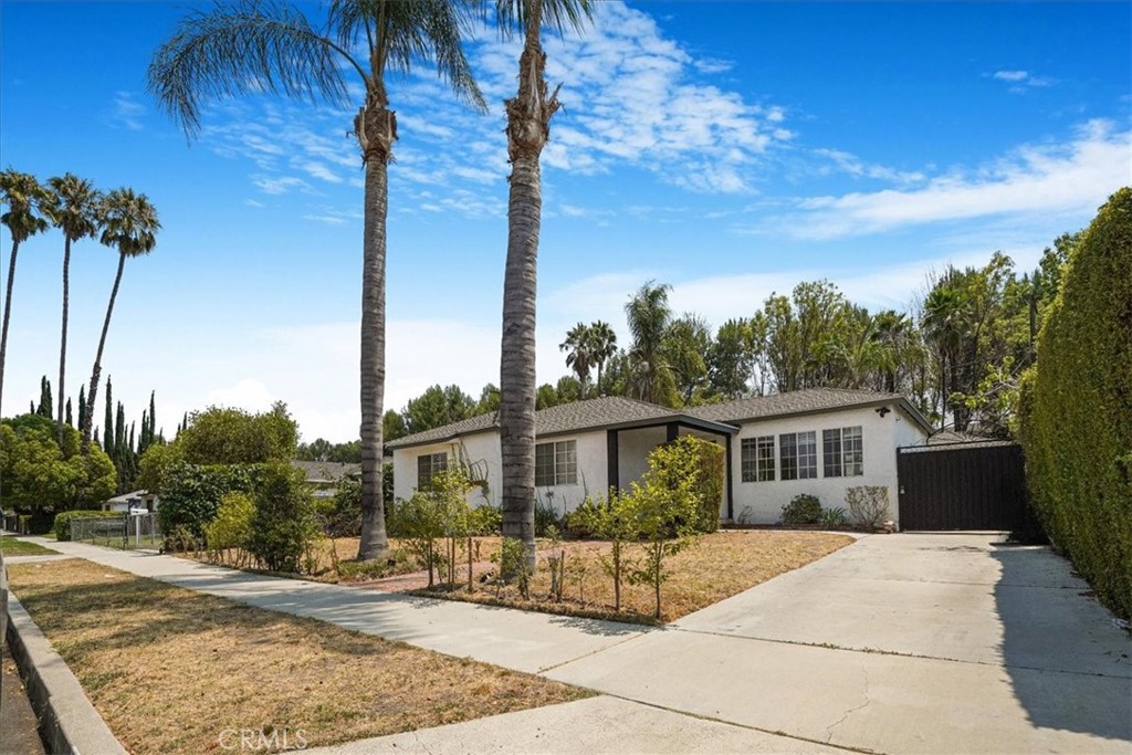 Welcome to your new home located in a highly sought area of Tarzana, CA. This beautifully updated home offers 3 bedrooms, 2 bathrooms, and 1,509 sq ft of living space on a spacious 6,206 sq ft lot. Inside, you’ll find laminate wood floors, recessed lighting, fresh paint, and an abundance of natural light throughout. The modern kitchen features brand-new cabinets, sleek countertops, and a functional layout perfect for entertaining. Both bathrooms have also been tastefully remodeled. The attached garage has been transformed into a versatile space with finished walls, an AC unit, and a layout that includes 2-car parking plus an additional area currently used as a home office—ideal for remote work or creative space. Step outside to a large backyard with endless possibilities, plus a generous driveway offering possible RV access. Located in a quiet Tarzana neighborhood near shops, restaurants, and freeway access, this move-in ready home is a must-see!