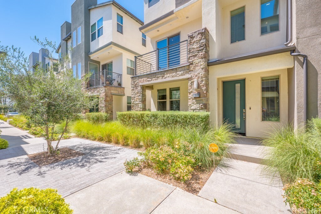 Welcome to modern luxury living in the heart of Northridge! This stylish townhouse at The District offers 2,078 sq ft with soaring ceilings, recessed lighting, and tasteful upgrades. The first floor includes a front porch, attached 2-car garage, and private guest suite. The open-concept second level features a spacious living room, dining area, balcony, and chef’s kitchen with quartz counters, walk-in pantry, and GE stainless steel appliances, plus built-in surround sound. Upstairs, the primary suite boasts dual vanities, frosted glass barn door, walk-in closet, and private water closet, with two additional bedrooms sharing a full bath. Enjoy a gated community with pool, spa, BBQs, and events, all near shopping, dining, and entertainment!