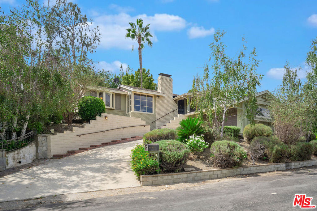 This timeless residence offers a one of a kind home with Guest House-Nestled in the heart of Studio City. This property is located in one of the most coveted and sought after neighborhoods South of the Boulevard. 12952 Greenleaf Street offers a rare blend of charm and modern livability. The entire residence including the guest house spans approximately 2224 square feet, showcasing 3 bedrooms and 3 baths thoughtfully designed with vaulted, wood-beamed ceilings, light-filled living spaces, a warm fireplace, and a seamless indoor-outdoor flow along with breathtaking views. Every detail reflects a balance of character and comfort, from the hardwood and tile flooring to the open and versatile floor plan.Elevating the property's appeal is a beautifully appointed guest house, offering over 650 of the 2224 square feet of flexible living space, not to mention the $$$ rental opportunity this permitted home brings. With its own bedroom and bath, private deck, and serene valley and mountain views, this detached retreat is perfect as an office, studio, or guest quarters or simply a place to call home. Together, the two residences are set on a lushly landscaped 7,814 square foot lot with terraced gardens and tranquil outdoor settings.This enchanting property embodies Studio City living at its finest- offering privacy, versatility, sophistication, along with extreme walkability as it's just steps from the boutiques, shops, cafes, and amenities along Ventura Boulevard.