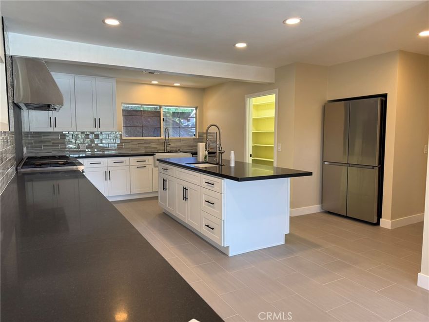 Contemporary luxury home with Panoramic views of Woodland Hills.  This fully remodeled home offers 2962 sq ft if refined living space, ideally situated south of Ventura Boulevard on a quiet street in one of the valley's most desirable neighborhoods. All new light hardwood floors throughout the home.  The kitchen is complete with new island, cabinets, new light plank floor, 10 burner Viking stove and oven.  This home is filled with natural light.  Includes refrigerator and washer and dryer (all Samsung).  Large walk-in pantry, fresh paint, amenities galore.  This home is complete with modern conveniences including an EV charging station, low maintenance landscaping, etc.  Double pane windows throughout the home, fireplace in the living room completely renovated.  Downstairs is a huge family room with fireplace and backyard patio with amazing views.  Conveniently located near the Village, Westfield Topanga, Ventura Blvd., dining, Trader Joe's with easy access to the 101 freeway and only 20 minutes to Malibu beaches.