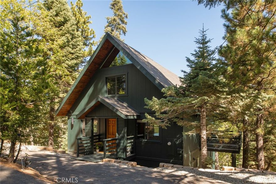 Tucked within Lake Arrowhead's coveted Lanes neighborhood—just steps from local favorite Orchard Bay Beach—this completely refreshed mountain retreat blends elevated, modern design with timeless charm. A rare and desirable level entry welcomes you into a space where modern craftsmanship shines. The custom kitchen is a true showpiece, featuring walnut cabinetry, soapstone counters, and all-new fixtures, while the entertainer’s floor plan connects open living spaces and multiple decks that invite both privacy and connection. Engineered wood flooring flows throughout, anchoring the home in warmth and style.



Every detail reflects thoughtful updates: the home has been repainted inside and out and fully refreshed with new lighting and sliding glass doors. Each of the four remodeled bathrooms offers custom vanities, stone countertops, new tile and fixtures, creating a cohesive sense of understated luxury.



With two primary suites, central A/C, generous storage, and parking for four, this home balances creativity and comfort. Set on a nearly quarter-acre lot, there’s potential room for a future ADU or garage—all just minutes from Lake Arrowhead Village and the shops at Cedar Glen, this home offers lake rights and a lifestyle that feels equal parts peaceful and inspired.



Whether you're seeking a weekend getaway, a forever home, or a short-term rental when life calls you elsewhere, this Lake Arrowhead retreat is ready to welcome you home.