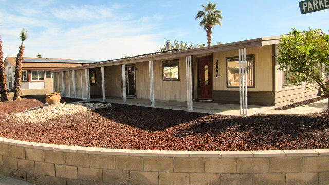This home is on a large corner lot with panoramic mountain views at a great low price! This unique property is on tags for possible tax savings but also qualifies for a loan if desired. To add to the desirability of this corner view home, solar has been installed with low monthly payments on a lease program. Enter into the living area with cathedral ceilings, a wood fireplace and a wet bar for entertaining. There are 3 bedrooms, one which is off the second bedroom and could be used as an office or den. The kitchen has an eating bar and plenty of storage. The spacious front patio has a screened area for privacy and adds a whole other space for relaxing and enjoying the mountain view.