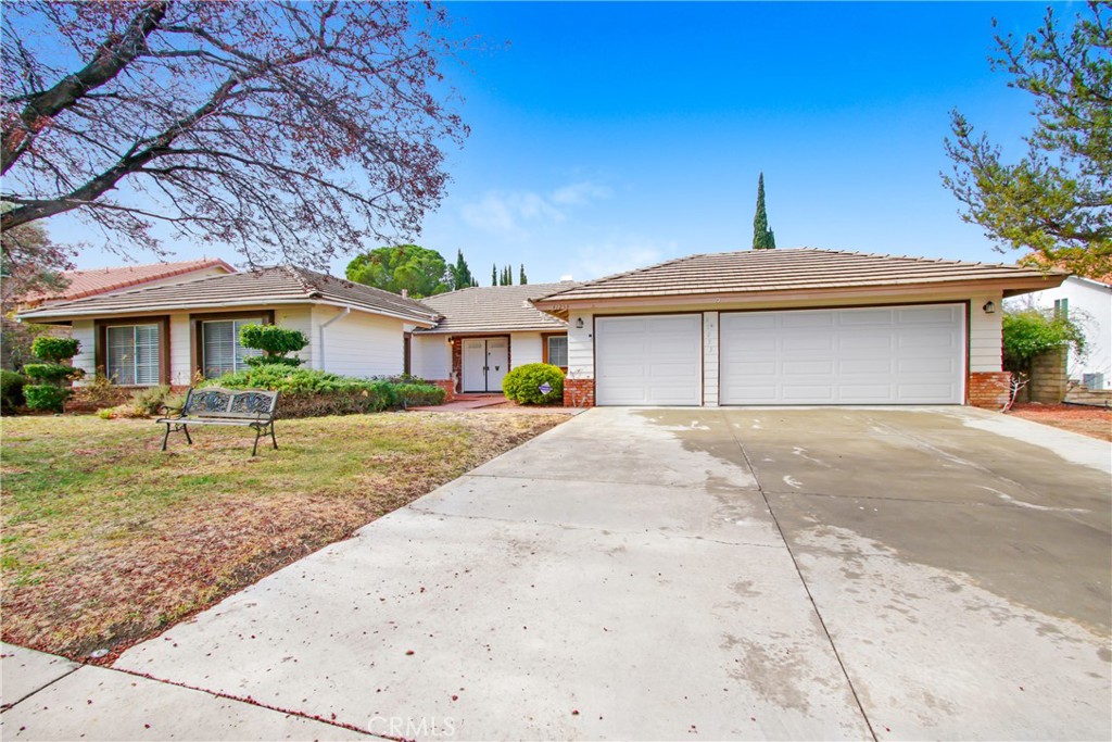 Immerse yourself in the charming atmosphere of this home, ideally situated in the desirable Quartz Hill neighborhood of West Palmdale, where comfort and practicality come together to create the ultimate living space. Through double entry doors, step into a welcoming foyer that leads to four generous bedrooms and three beautifully designed bathrooms. As you enter, the foyer opens to a spacious living room with soaring ceilings which greets you with warmth and sophistication, offering expansive living areas ideal for both hosting guests and enjoying intimate family moments. Abundant natural light pours through large windows, filling each room with a bright, inviting ambiance. Both the living and family rooms boast their own fireplaces, creating a warm and cozy atmosphere. This home has been updated with contemporary finishes, including brand-new flooring, baseboards, modern light fixtures, and a fresh coat of paint throughout. The kitchen has been meticulously redesigned, showcasing new cabinets, quartz countertops, farmhouse sink, and modern appliances. Recessed lighting enhances the space, and the kitchen offers direct access to a spacious three-car garage, which includes a convenient pull-through to the backyard. Adjacent to the kitchen, you'll find a stylish and updated wet bar area. Nestled along peaceful, tree-lined streets, this fantastic neighborhood is just minutes from top-rated schools, shopping, and dining options. Don't miss the opportunity to call it home!