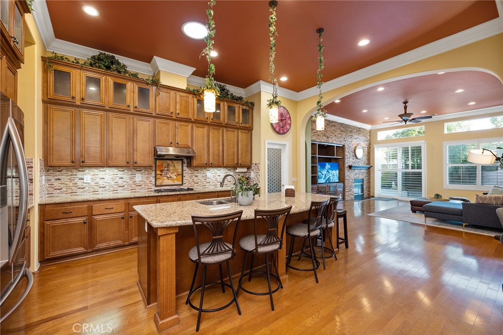 Warm and Welcoming, this Well-Maintained SINGLE LEVEL HOME in South Temecula with an extra Tall 3-car wide garage offers Single Story Living at its Best! If you love Entertaining, Tall Ceilings, HUGE Kitchens, and separation between Main Bedroom Suite and Guest Quarters, this Home is for YOU! Everything about this Residence feels spacious and extra large. Crown Molding, Stacked Stone Accent Wall, Gorgeous Dining Room (optional 5th bedroom or another Office), Plantation Shutters throughout, Enormous Living Room that could hold a Pool Table or Grand Piano, or be the space for a at home yoga studio or day care. Impressive Office with high end Built-ins (easily turned into Bedroom #4, with a designated closet Nook already in place) Wood Floors, Tile in wet areas, and Carpet in sleeping areas, Easy/low-maintenance backyard with Fruit Trees (Jujube apples, Honeycrisp Apples, Asian Pears, Meyer Lemons, Pomegranate), extra Privacy with no direct neighbor behind. Newer 5-ton HVAC system (installed in 2023), Cat 5 ethernet cables in every room, Home Security Alarm connected to Police, You will love living here - Blue Ribbon Schools, Dining and Shopping within walking distance, Gateway to Wine Country, and Easy Access for Commuters!