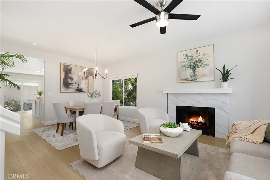 Welcome to this beautifully upgraded end-unit townhouse in the highly sought-after neighborhood of Woodbridge. Spanning 1,406 square feet, with 3 bedrooms and 2.5 baths, this light-filled, two-story residence is ideally located at a quiet cul-de-sac, boasting a rare, extra-large side yard adorned with lush green foliage and fruit trees. Step inside to discover a spacious living room accented by a cozy fireplace, abundant natural light, and new fresh designer paint throughout. Downstairs features newly upgraded Luxury Vinyl floors that complement the inviting kitchen and den area, complete with new quartz countertops, new tile back splash, white shaker-style cabinets, stainless steel appliances, and recessed lighting and eat at island. Upstairs, you'll find upgraded bathrooms with newer floors, faucets, high-end roller shower/tub door enclosures as well as new neutral carpet, new ceiling fans, and new custom-ordered mirrored closet doors. Enjoy the convenience of newer windows and patio doors with dual-pane glass, enhancing energy efficiency and tranquility. This townhouse offers more than just a home; it provides a lifestyle within the resort-like amenities of Woodbridge. Residents enjoy access to two lakes with docks, two beach lagoons, over 15 swimming pools and spas, including saltwater heated pools, along with over 20 tennis courts and several pickleball courts. The community also features numerous parks with playgrounds, volleyball courts, and scenic tree-lined streets perfect for leisurely walks. Located within the top-rated Unified Irvine School District, residents benefit from proximity to Springbrook Elementary, Lakeside Middle School, and renowned Woodbridge High School, all within walking or biking distance. Easy access to major routes such as I-405 and I-5 makes commuting a breeze, while world-class shopping, dining, beaches, UCI, and the Irvine Business Complex are just moments away. With no Mello Roos tax and one of the most central and desirable locations in Irvine, this special home offers a rare opportunity that won't last long!
