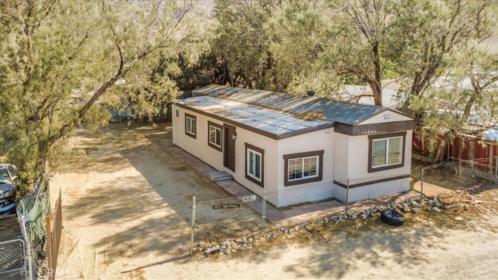 Location, location... looking for affordable living? Check out this newly remodeled 3-Bed, 2-Bath Mobile Home with Bonus Room & Mountain Views in Cabazon. This 3-bedroom, 2-bathroom home includes a flexible bonus room—perfect for a home office or hobby space. The updated kitchen features quartz countertops, a double sided stainless steel sink, modern appliances, and plenty of cabinet space. Private remodelled bath with a new tub/shower combination and vanity. The guest bath includes a walk-in shower and modern finishes. Spacious family room flows conveniently to kitchen, bedrooms and baths. Brand new central A/C offers year-round comfort with central heat as well. New flooring and paint throughout adds to the charm. The fully fenced lot includes a gas line for exterior laundry hookups or possible outdoor kitchen setup. Located in a neighborhood near I-10, Morongo Casino Resort & Spa, Desert Hills Premium Outlets, and the iconic Cabazon Dinosaurs. Lower taxes, you own the land with no space rent, and no HOA make this an excellent opportunity for homeowners or investors.