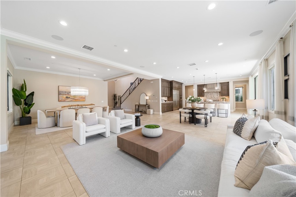 This exquisite luxury residence sits on a 6,500 sqft premium corner lot, offering exceptional privacy and abundant natural light. Designed as a professionally upgraded model home, it features an open-concept floor plan with a gourmet kitchen, expansive great room, and elegant dining area. The chef-inspired kitchen comes fully equipped with a built-in Sub-Zero refrigerator, Wolf range, professional hood, microwave, dishwasher, designer backsplash, and premium countertops. The first floor includes an en-suite bedroom, a stylish powder room, and a spacious flex area ideal for a home office or guest suite. Upstairs, a versatile loft connects three en-suite bedrooms, including a lavish primary suite with dual walk-in closets, a spa-like bathroom with a walk-in shower, and an extended private balcony. Elegant hardwood flooring runs throughout the home, highlighting its refined craftsmanship and attention to detail. Residents enjoy exclusive access to resort-style amenities, including a private clubhouse, tennis courts, bocce ball, sports parks, and scenic walking trails.