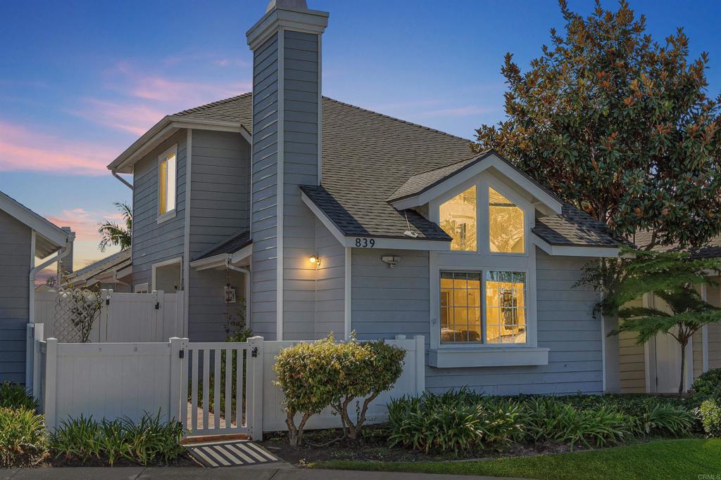 Welcome to 839 Skysail Avenue, located in the gated community of Harbor Pointe. Tucked at the end of a quiet cul-de-sac, this Cape Cod–style home blends coastal charm with modern comfort. Bright and airy with vaulted ceilings, large windows, and engineered wood floors throughout the main living areas, with tile flooring in the kitchen and bathrooms. The inviting living room features a brick fireplace and flows to the dining area and private patio for easy indoor/outdoor living. The kitchen offers granite countertops, a decorative tile backsplash, recessed lighting, and stainless steel appliances—ready for your personal touch. The functional floor plan includes a downstairs bedroom and full bath, with the primary suite and additional bedroom upstairs. New carpet has just been installed in the bedrooms and stairs. More recent improvements include fresh interior paint, a new HVAC system with air conditioning, and a new water heater. Previous upgrades completed include dual-pane windows, vinyl fencing, roof, and exterior paint. The exterior patio is beautifully hardscaped with brick walkways—perfect for relaxing or entertaining. Community pool/spa, gated entry, and only 1.1 miles to the beach. Centrally located near restaurants, shopping, and freeway access, within the Carlsbad Unified School District and a short distance to Pacific Rim Elementary. Don’t miss this rare opportunity to own in one of Carlsbad’s most sought after coastal communities!