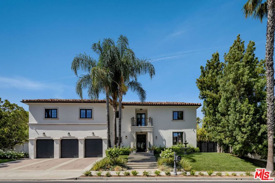 Nestled within the coveted guard-gated enclave of Monte Verde Estates and bordering the prestigious El Caballero Country Club, this Montecito-inspired Spanish estate blends timeless elegance with modern innovation. Behind an oversized metal front door, you're met with a dramatic rotunda foyer with a skylit stairwell and sweeping spiral staircase, illuminated by motion-activated LED stairs, offering a striking first impression. Expansive metal windows and custom doors invite natural light and serene hillside views, reinforcing a seamless connection to nature. The main level is designed for both grand entertaining and everyday comfort. Two bedrooms flank the great room and formal living room, anchored by a 20-foot genuine Calcutta gold marble fireplace and a custom wet bar. A temperature-controlled wine cellar adds a refined touch for the wine enthusiast. The formal dining room featuring a stunning Tom Dixon chandelier overlooks a lush putting green and transitions effortlessly into the gourmet chef's kitchen, appointed with Calcutta marble countertops, Leicht cabinetry, Porcelanosa tile, and professional-grade stainless steel appliances. The kitchen opens into a relaxed family room with a fireplace and extends outdoors through a roll-away wall pocket doors to an expansive covered terrace, equipped with multiple heaters. Experience numerous lounge and dining areas that frame the outdoor kitchen, firepit, pool, spa, TV, and lighted sport court, creating a private resort-like sanctuary. Upstairs, a recreational room with en-suite bath can easily be converted to a seventh bedroom, and is complemented by three additional en suite bedrooms, each uniquely designed with Porcelanosa bathroom hardware and distinct finishes. The primary suite crowns the residence with a sitting area and fireplace, Tom Dixon chandelier, private viewing deck, and a spa-inspired bath featuring a jetted tub, steam shower, dual vanities, and two custom walk-in closets. This estate integrates state-of-the-art technology throughout, including a whole-home Crestron system, LED baseboards, full surround sound, and 23 cameras providing top-tier security. iPads are conveniently placed in all main rooms for intuitive control of lighting, climate, entertainment, and more.  Additional highlights include a dream garage with Omer Ferrari double liftsperfect for the car fanatic. Meticulously upgraded and designed to embody modern luxury, this estate stands as one of the finest offerings within a premier gated community. Just moments from fine dining, shopping, and top-rated schools, it captures the perfect balance of elegance, technology, and convenience.
