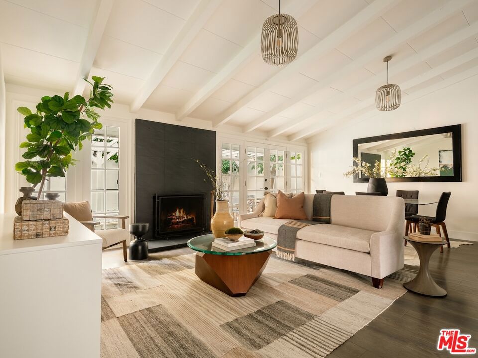 Situated on a sun drenched corner lot, this beautifully renovated pool home offers nearly 2,000 square feet of stylish living, blending comfort, functionality and charm. Featuring 4 bedrooms, 2 bathrooms and a versatile bonus room with its own private entrance, the space is ideal for a potential ADU, home office, gym, playroom or creative studio limited only by your imagination. The open concept layout is enhanced by soaring vaulted ceilings, creating a bright and expansive atmosphere from the moment you enter. At the heart of the home, a thoughtfully updated kitchen showcases a large island with ample storage and seating perfect for entertaining or casual family gatherings. Step outside to your own private oasis, where a sparkling pool and generous covered patio invite year round enjoyment, from backyard BBQs to starlit evenings. Whether you're looking for a forever home, an investment opportunity, or a flexible layout to adapt as your needs change, this corner-lot gem in one of Van Nuys' best kept secret neighborhoods delivers. Don't miss it. Homes with this kind of potential are rare!