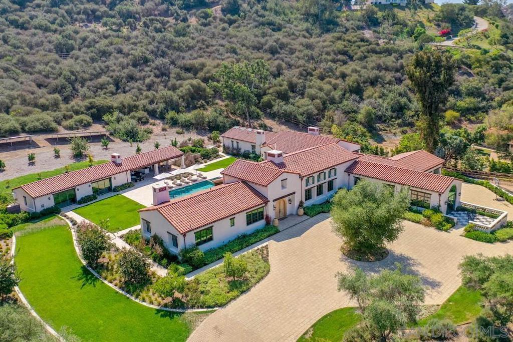 Newly constructed single-level equestrian estate in the Rancho Santa Fe Covenant’s most coastal location exemplifies sophisticated design and quality in every detail. The very private main home features a stunning open kitchen, soaring vintage barn wood ceilings, custom French Oak flooring and walls of glass that open to pool, lawns, spacious pool house, outdoor kitchen and living areas. The 7+ acre estate includes a separate 2 bed, 2 bath guest home with full kitchen and patio plus a 3,670 sf custom barn with clubhouse all built to the same impeccable standards. Additional horse amenities include a large, competition-sized arena with top footing, round pen, eurowalker, large paddocks and direct access to miles of RSF’s best trails. Solar power and an excellent well with filtration system make this estate as operationally efficient as it is beautiful. Main residence includes apx. 7,588 sf of living space with 4 bedrooms, 4 full baths and two powder rooms, large open kitchen, plus adjacent “dirty kitchen”, great room, formal dining room, family room, gorgeous master suite, large and second smaller office, library, laundry room and 4 car attached garage. Detached guest house includes approx. 1,150 sf with 2 bedrooms, 2 baths, kitchen, living room, and private patio. Pool house includes approx. 954 square feet with two large rooms suitable for gym, theatre and many other purposes with one full pool bath and one half bath. Barn includes stalls, tack room, cross tie and wash rack areas, storage areas, full laundry room and clubhouse with patio overlooking riding arena and pastures. Other amenities include irrigated 190 x 165 arena with sand and Euro felt footing, round pen, eurowalker, 5 large pastures, solar panels that provide electricity and an excellent well with filtration system that provides water for the entire property. Architectural Style: Custom Built View: Custom Built Equipment: Dryer,Fire Sprinklers,Garage Door Opener,Pool/Spa/Equipment, Washer, Water Filtration Sewer: Sewer Connected Topography: LL Guest House Est. SQFT: 1150
