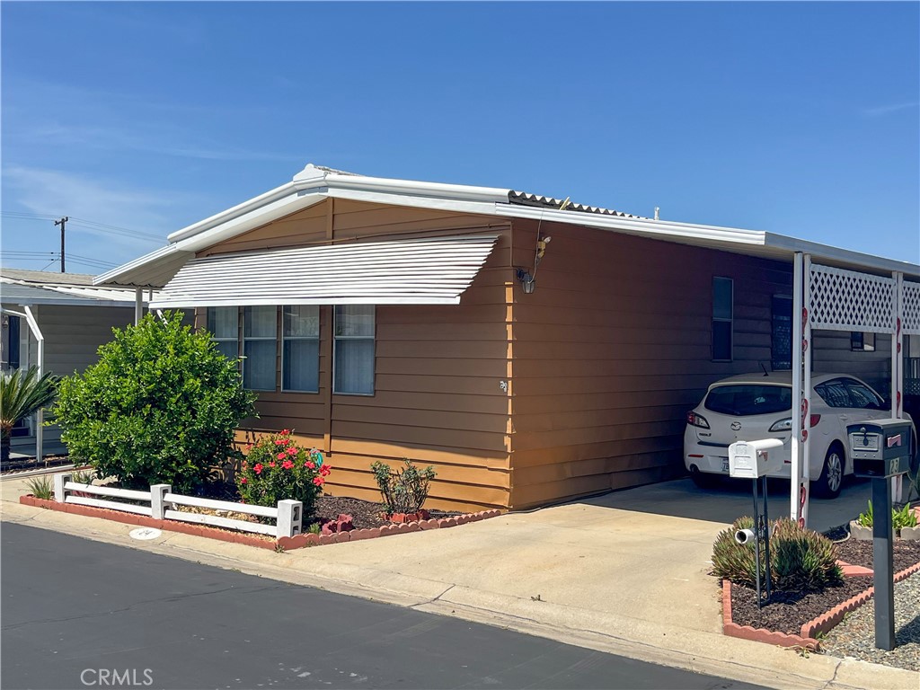Seller is motivated to sell, and will entertain all offers! What a Wonderful opportunity to live in Villa Magnolia, a 55+ Community in Riverside, they have lots of activities and events, a beautiful clubhouse, pool and spa. Welcome to this inviting home, featuring a split floor plan with 2 bedrooms, each with adjoining bathrooms. The bedrooms are nicely sized and the primary has a Large walk-in closet. The living room is very spacious and is the center of the home, with direct access to the dining area that opens to the kitchen. The kitchen is equipped with, a gas range, dishwasher, refrigerator, and counter-top microwave oven. Just off the kitchen is a laundry area that includes a full-size washer and dryer, overhead cabinets, and additional storage with shelves. There is flooring throughout the home, new a/c (2024), heating, and the exterior of the home was painted in 2024. The exterior of the home is large with low maintenance (concrete and rocks), there are (2) sheds, a block wall on the back perimeter. The sale price of this home includes All furniture and the outside barbecue. All the home needs is for you to pack your bags and move in!