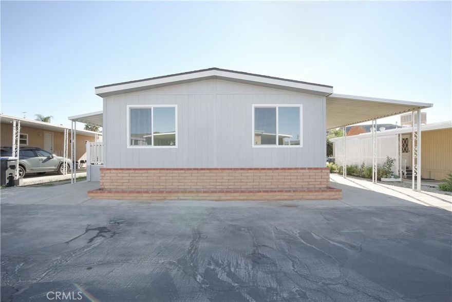 Welcome to ALL AGE Vista De Oro Mobile home park! Unit 104 has been newly renovated and ready for its new owner in a beautiful and quiet community! As you enter the home, you will find an open concept layout, kitchen is equipped with all brand new countertops, cabinets, stove, sink, faucets and dishwasher. Just off the Kitchen is the primary bedroom with a walk in closet and the master bathroom has new toilet, sinks, cabinets and resurfaced tub/shower combo. On the other side of the kitchen you will find the laundry room, washer and dryer hook-ups with access to the carport. Down the hall you will also find a BONUS ROOM for an office!  You can also enjoy a brand new fully shaded porch and a two car parking port. OTHER UPGRADES: New roof, new windows, new water heater, new bedroom closet doors, new siding, new laminate waterproof flooring throughout, plumbing, new paint inside and out, new foundation support beams and all brand new foundation installation of the mobile home with earthquake system.  Conveniently close to parks, Orange groves, shopping centers, Valle Vista Elementary school, Hemet High school and much more! Park approval needed, Space Rent $912 mo, 5 year lease, Sold as is condition, buyer do your due diligence. Raise your family in a safe neighborhood with breathtaking views of our valley's mountains, as well as enjoying the cool and the fresh air the surrounding orange groves provide! Don't miss out, schedule your appointment now!