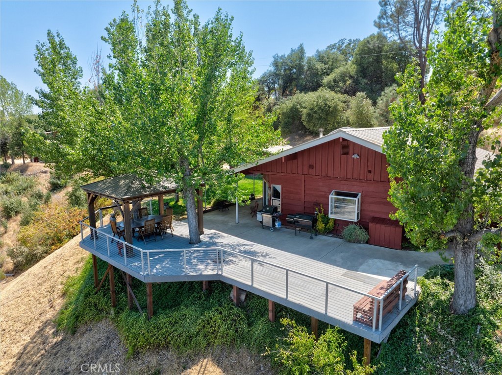 Nestled on nearly 15 acres of scenic rolling hills, this charming 3-bedroom, 2-bathroom single-family home offers peace, privacy, and panoramic mountain views. With approximately 1,350 sq ft of comfortable living space, this property is perfect for those seeking a retreat from the hustle, whether as a full-time residence, weekend getaway, or multi-use investment. Beyond the main house, you'll find additional buildings including a 225 sq ft detached bunkhouse ideal for guests, a studio, or private office. A two-car carport provides sheltered parking, while the expansive acreage offers endless potential: garden, graze, build, or simply enjoy the serenity. Located in Ahwahnee, just a short drive to Yosemite and the amenities of Oakhurst, this property combines rural tranquility with year-round accessibility. Whether you're looking for a quiet mountain home or a base for your next chapter, this one has room to grow.