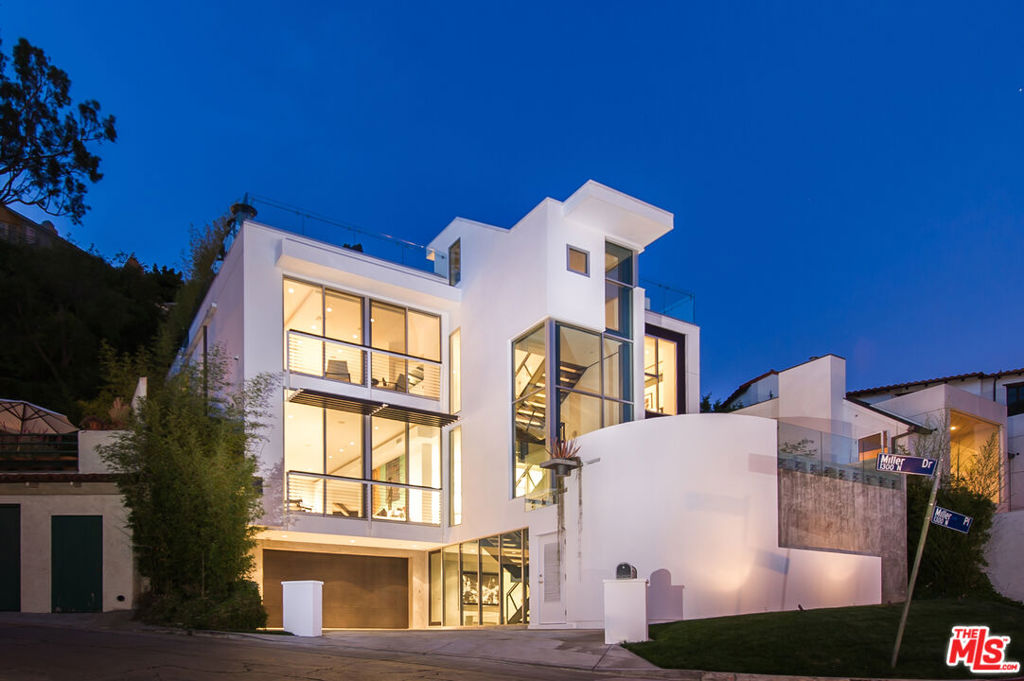 Dazzling architectural view home above Sunset in Doheny Estates marked by excellence in craftsmanship + design. Created by Award-Winning Harrison Design+Assoc, the striking facade is a virtual wall of windows providing endless views + abundant light throughout. Open, airy floorpan w/ multiple levels allows for the enjoyment of separate areas accessible by stairs or glass walled elevator, with spatial cohesion in mind. Interior space is defined by clean lines combined with gentle curves, designed with an attention to detail and use of quality finishes, incl. Carrera counter tops, exquisite stone surfaces, white oak floors, and glass-ceilinged hallways, as well as top-grade appliances. Expertly lending itself to indoor/outdoor entertaining, features incl media room w/ bar, expansive rooftop deck w/ stunning views, lounge area w/ bbq center, jacuzzi, surround sound system, pool on main level perfectly positioned off outdoor dining area, f/p and kitchen. An exceptional home like no other. Also available for 6 month short-term at $24,900 per month.