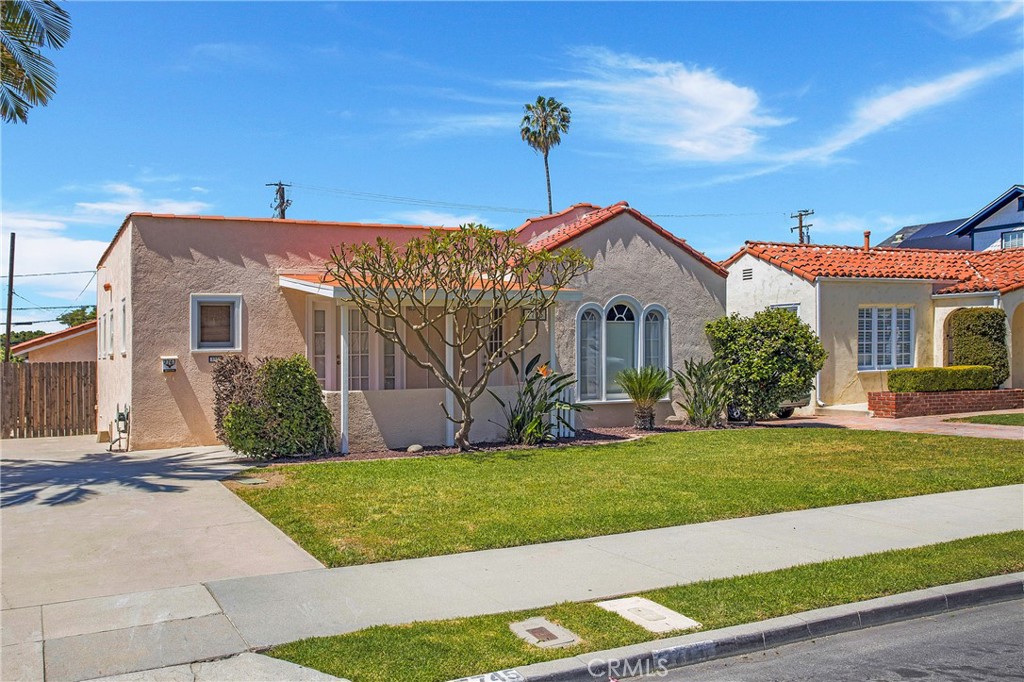 Welcome to this beautifully maintained 3-bedroom, 2-bath home located just minutes from Whittier College in the heart of Uptown Whittier. Full of character and charm, this home blends classic details with modern updates. The kitchen features oak cabinets, tile countertops, and tile flooring — a tasteful update done some years ago. Freshly painted throughout with updated light fixtures, the interior feels bright and inviting. Original hardwood floors, wood-framed windows, and solid wood doors add warmth and timeless charm. Enjoy your morning coffee on the front patio, accessed through elegant French doors, while soaking up the Southern California sunshine. For year-round comfort, the home includes mini-split AC/heat units in the living room and front bedroom, as well as window AC units in the primary and third bedrooms. A large two-car garage offers ample storage space (please note: not available for vehicle parking). Don't miss this opportunity to live in a character-rich home in a highly sought-after location!