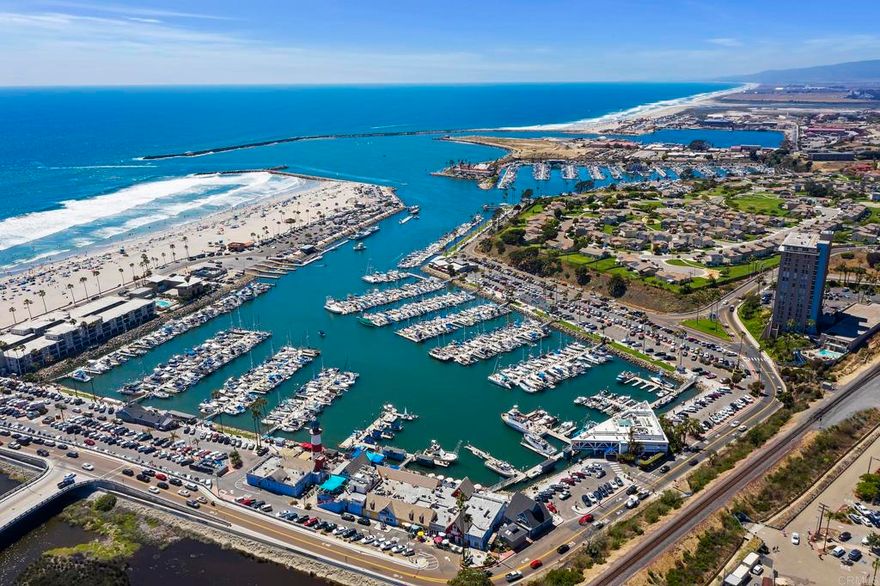 Whitewater Pacific Ocean and Oceanside Harbor views! This is the only highrise condo building on the coast for miles, and this unit gives you the added southern views on the “A” side of the building. Relax on your private balcony while watching the boats drift in and see the surfers catch the last wave as the sun sets. One of the best locations in SoCal, this is a rare opportunity to live your dream! Kitchen has been recently remodeled with newer high-quality cabinets with pull-outs and soft-close drawers, along with luxurious white quartz counters and newer appliances. As with most units in the building, the wall has been removed between living room & second bedroom to create an open living area with built-in entertainment center. Hi-end solar shades throughout the living areas. Hall bath has been remodeled with elegant custom tile, newer fixtures. Master bedroom has a roomy walk-in closet and adjoining remodeled bath. Hallway laundry center has been refreshed with newer washer/dryer and tankless water heater. Amenities in the Towers include a pool, a spa, a barbecue, gated parking, an updated recreation/meeting room, an exercise room and a secure building. Dues also cover your WIFI, basic cable, water, and on-site full time building manager. Make this prestigious address at 1200 Harbor Dr N yours and enjoy beach life! Surf's up!