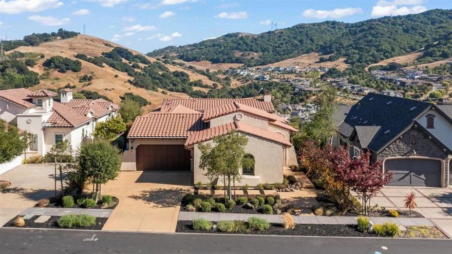 This Mediterranean-style home with stunning panoramic views in Orinda's Wilder community blends timeless elegance with modern functionality. A private courtyard, soaring ceilings & natural light define the open layout, where the chef's kitchen, equipped with high-end appliances including a steam oven & wine refrigerator, flows into a spacious dining area & family room, ideal for both entertaining & everyday living. The 5-panel accordion door with wireless-controlled shades opens to an expansive deck, while numerous French doors & windows enhance indoor-outdoor connection. 3 en-suite bedrooms, including the luxurious primary suite, are located on the lower level for added privacy. A fourth en-suite bedroom is on the main level & features a private entrance- ideal for guests, a nanny, or an office. 2.8 miles from BART (26 min commute to SF). 6 miles from UC Berkeley. Wilder residents have access to the stunning $8M Quarry House w/competition pool, fitness center, & patios overlooking Mt. Diablo, 5 play fields, 6,600 SqFt Art & Garden Center with galleries & outdoor amphitheater, & 1,300 acres of open space & trails.  21 Bigleaf's high-end finishes, functional layout, proximity to top schools, world class views, & resort-style community amenities define East Bay living at its best.
