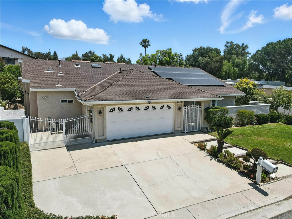 Welcome to this beautiful one-story 4-bedroom, 3-bathroom home in the Prestigious Porter Ranch Country Club neighborhood. With a gated entry for added security, this home offers style, comfort, and modern amenities in a tranquil setting. Enter through the formal entry to a spacious living room with cathedral ceilings, crown molding, recessed lighting, custom remote blinds, and new luxury vinyl plank floor throughout the home. The updated kitchen features granite countertops, an electric oven with microwave, gas stove, skylight and a built-in custom granite dining table. The adjacent family room has dual pane sliding glass doors leading to the private oasis backyard. The primary bedroom includes custom wood shutters, crown molding, and an en-suite bathroom with a custom tile shower, upgraded cabinetry, and new luxury vinyl plank floor. Three additional generous size bedrooms share two more bathrooms. This home is equipped with an electric attic fan, dual A/C & Heater units, and Nest thermostats for comfort. The paid-off solar system (5.7 KW, 20 panels) and security system includes 5 security cameras at all corners of the house plus front doorbell camera add peace of mind. A separate entrance offers the potential for a Junior ADU, duplex or separate office. The large corner lot provides space for an ADU or expansion. The private backyard includes mature fruit trees, a custom covered patio 34' X 33' X 12 1/2', gas fire pit, and a brick planter with water & electricity. Additional features include a 2-car garage with a 220 charger, RV access and a corner lot on a cul-de-sac. The home is located within the boundaries of highly rated award-winning schools, including Castlebay Lane Elementary and Granada Hills Charter High School, making it an ideal location for families. Enjoy the convenience of being close to hiking trails, The Vineyards at Porter Ranch shopping center, coffee shops, Whole Foods, and a variety of restaurants. With easy access to major freeways, this home offers the perfect blend of peaceful living and urban convenience. Don’t miss the opportunity to own this beautiful one story home in one of the most desirable neighborhoods in Porter Ranch!