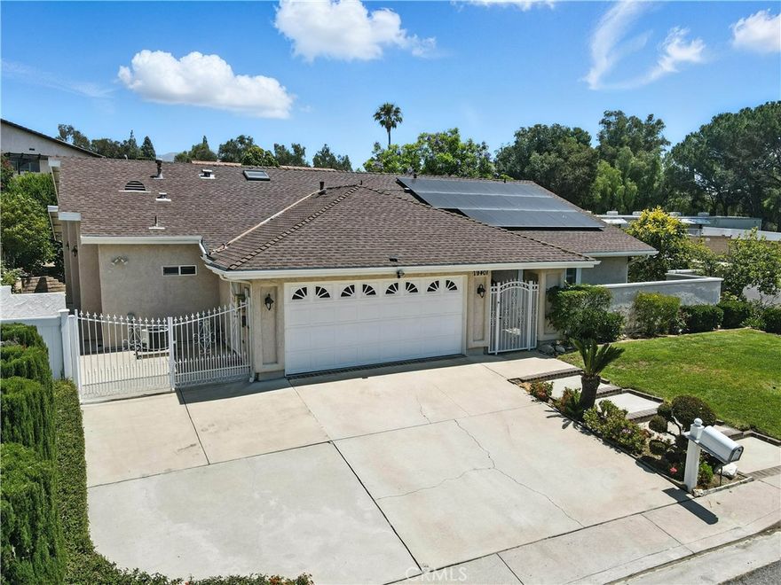 Welcome to this beautiful one-story 4-bedroom, 3-bathroom home in the Prestigious Porter Ranch Country Club neighborhood. With a gated entry for added security, this home offers style, comfort, and modern amenities in a tranquil setting. Enter through the formal entry to a spacious living room with cathedral ceilings, crown molding, recessed lighting, custom remote blinds, and new luxury vinyl plank floor throughout the home. The updated kitchen features granite countertops, an electric oven with microwave, gas stove, skylight and a built-in custom granite dining table. The adjacent family room has dual pane sliding glass doors leading to the private oasis backyard. The primary bedroom includes custom wood shutters, crown molding, and an en-suite bathroom with a custom tile shower, upgraded cabinetry, and new luxury vinyl plank floor. Three additional generous size bedrooms share two more bathrooms. This home is equipped with an electric attic fan, dual A/C & Heater units, and Nest thermostats for comfort. The paid-off solar system (5.7 KW, 20 panels) and security system includes 5 security cameras at all corners of the house plus front doorbell camera add peace of mind. A separate entrance offers the potential for a Junior ADU, duplex or separate office. The large corner lot provides space for an ADU or expansion. The private backyard includes mature fruit trees, a custom covered patio 34' X 33' X 12 1/2', gas fire pit, and a brick planter with water & electricity. Additional features include a 2-car garage with a 220 charger, RV access and a corner lot on a cul-de-sac. The home is located within the boundaries of highly rated award-winning schools, including Castlebay Lane Elementary and Granada Hills Charter High School, making it an ideal location for families. Enjoy the convenience of being close to hiking trails, The Vineyards at Porter Ranch shopping center, coffee shops, Whole Foods, and a variety of restaurants. With easy access to major freeways, this home offers the perfect blend of peaceful living and urban convenience. Don’t miss the opportunity to own this beautiful one story home in one of the most desirable neighborhoods in Porter Ranch!