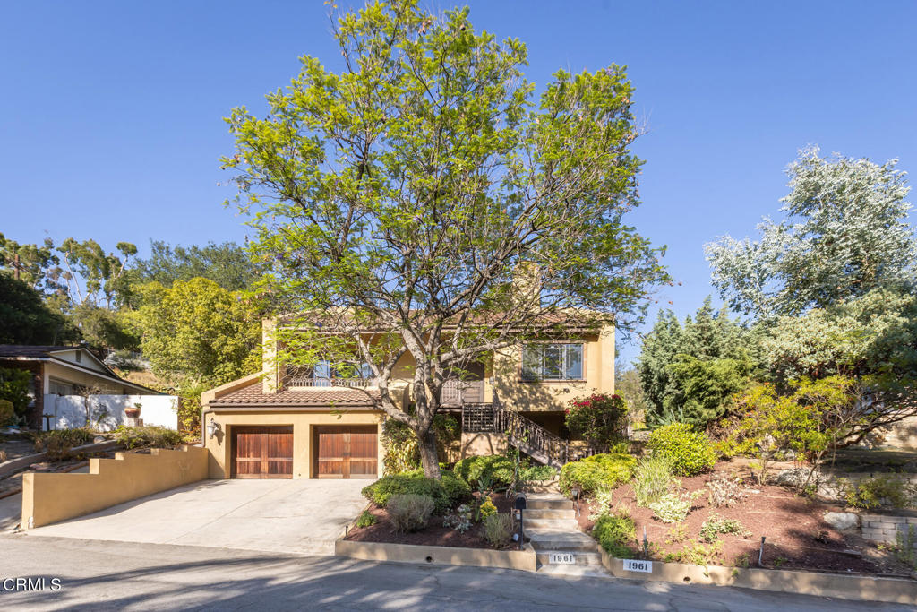 Welcome to this elegant Mediterranean estate in the coveted Montecito Park neighborhood of Glendale. Set on a peaceful street, this four bedroom, four bath home offers over 3,100 square feet of beautifully reimagined living space, with luxury finishes. A formal double-door entry opens to soaring vaulted ceilings in the living and dining rooms, where expansive picture windows frame serene views and fill the home with natural light. Off the dining room is a versatile converted study with built-in desk and bookshelves, originally designed as a wine cellar. The chef's kitchen features a generous center island, premium stainless steel Viking appliances, and an inviting eat-in area, ideal for casual gatherings. Upstairs, the private primary suite is a true sanctuary with a walk-in closet, spa-like bath with jetted tub and separate shower, and a private balcony overlooking the mountains. A spacious lower-level suite with its own entrance, patio, and walk-in closet is perfect for guests or multi-generational living. Additional highlights include two custom marble fireplaces, three-zone HVAC, and hardwood floors throughout. Located minutes from award-winning schools, Montrose shopping, dining, and freeway access.